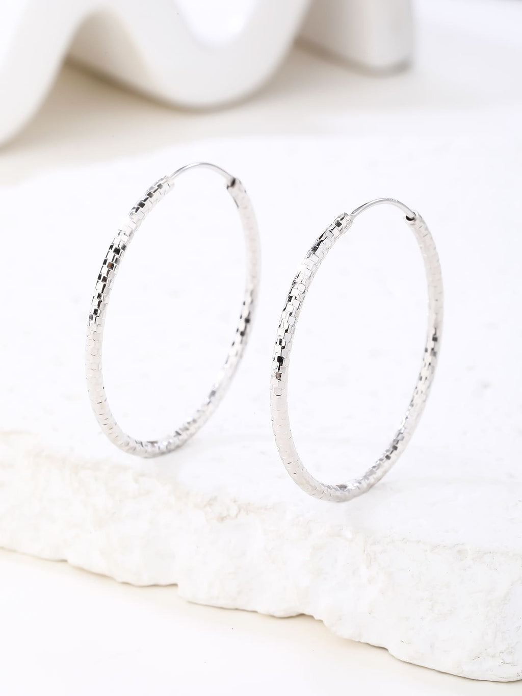3.5 cm diamond-engraved hoop earrings in hallmarked, rhodium-plated 925 sterling silver – display view – DRESCHER Jewellery®