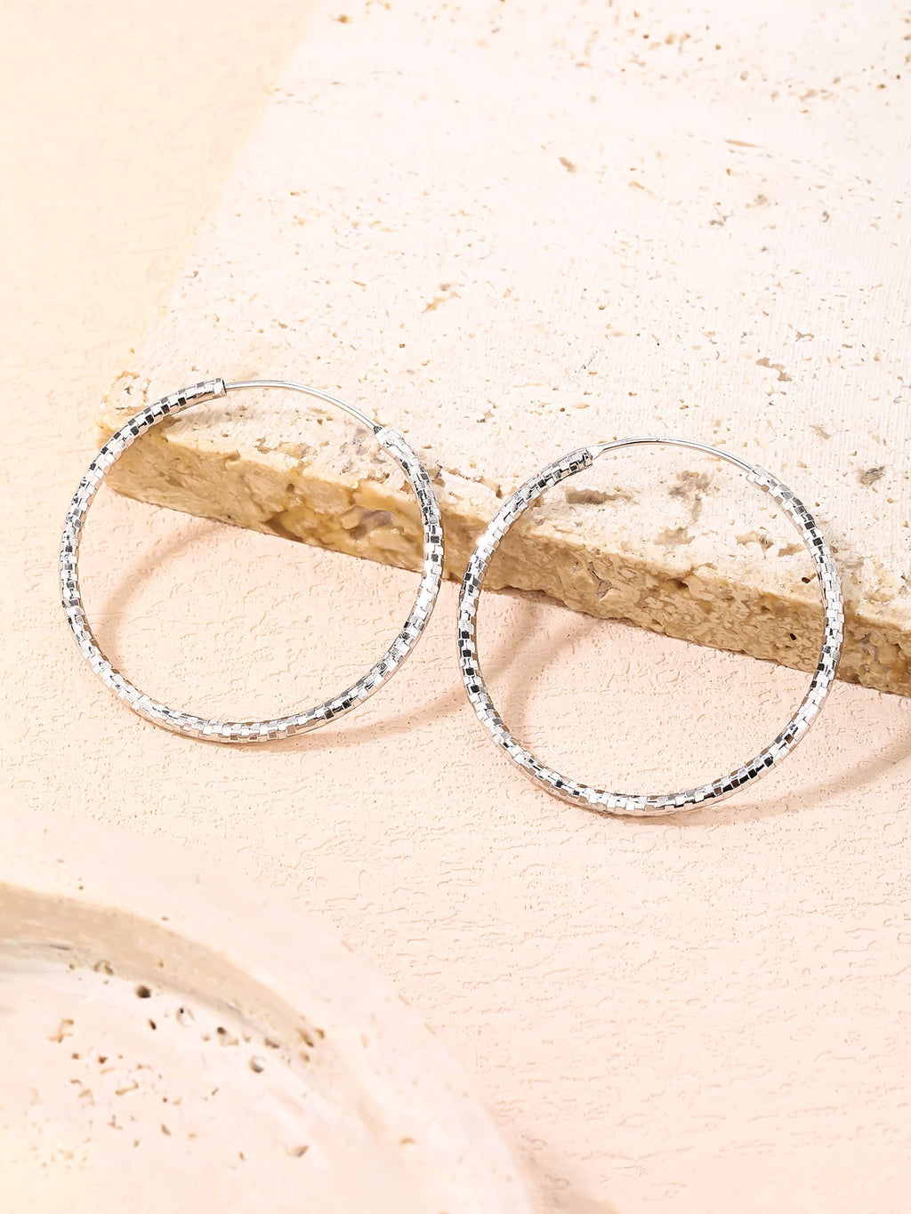 3.5 cm diamond-engraved hoop earrings in hallmarked, rhodium-plated 925 sterling silver – lifestyle view – DRESCHER Jewellery®