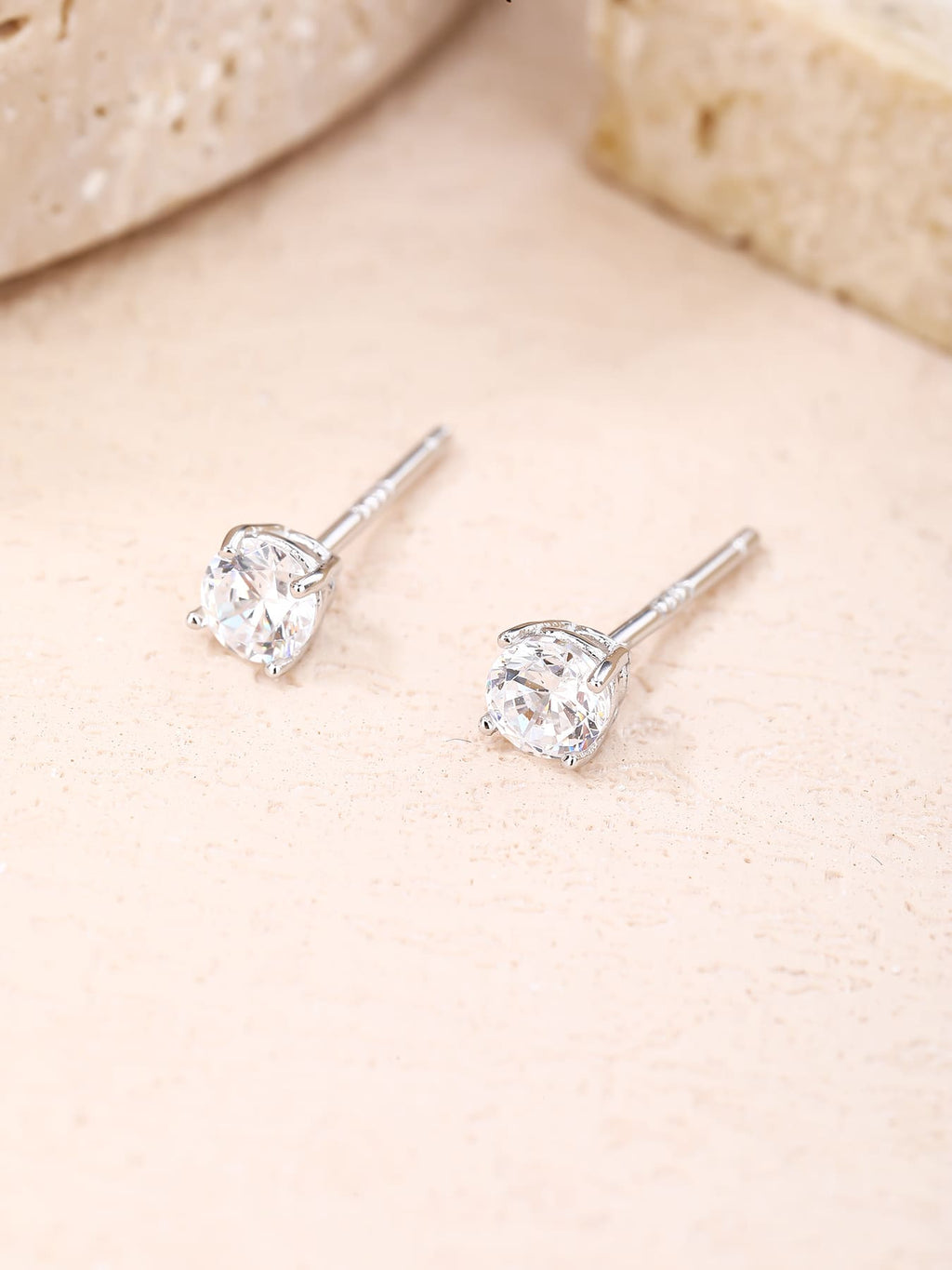 White cubic zirconia hallmarked, rhodium-plated 925 sterling silver stud earrings – lifestyle view – DRESCHER Jewellery®