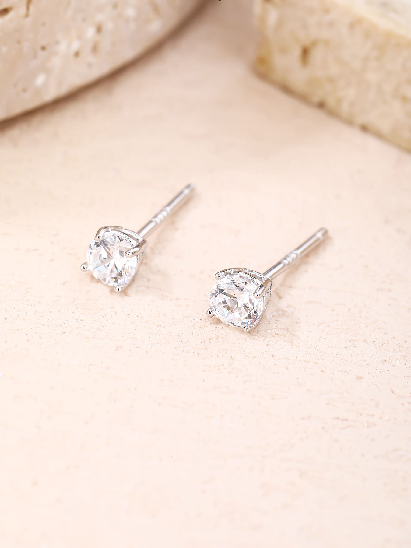 White cubic zirconia hallmarked, rhodium-plated 925 sterling silver stud earrings – lifestyle view – DRESCHER Jewellery®