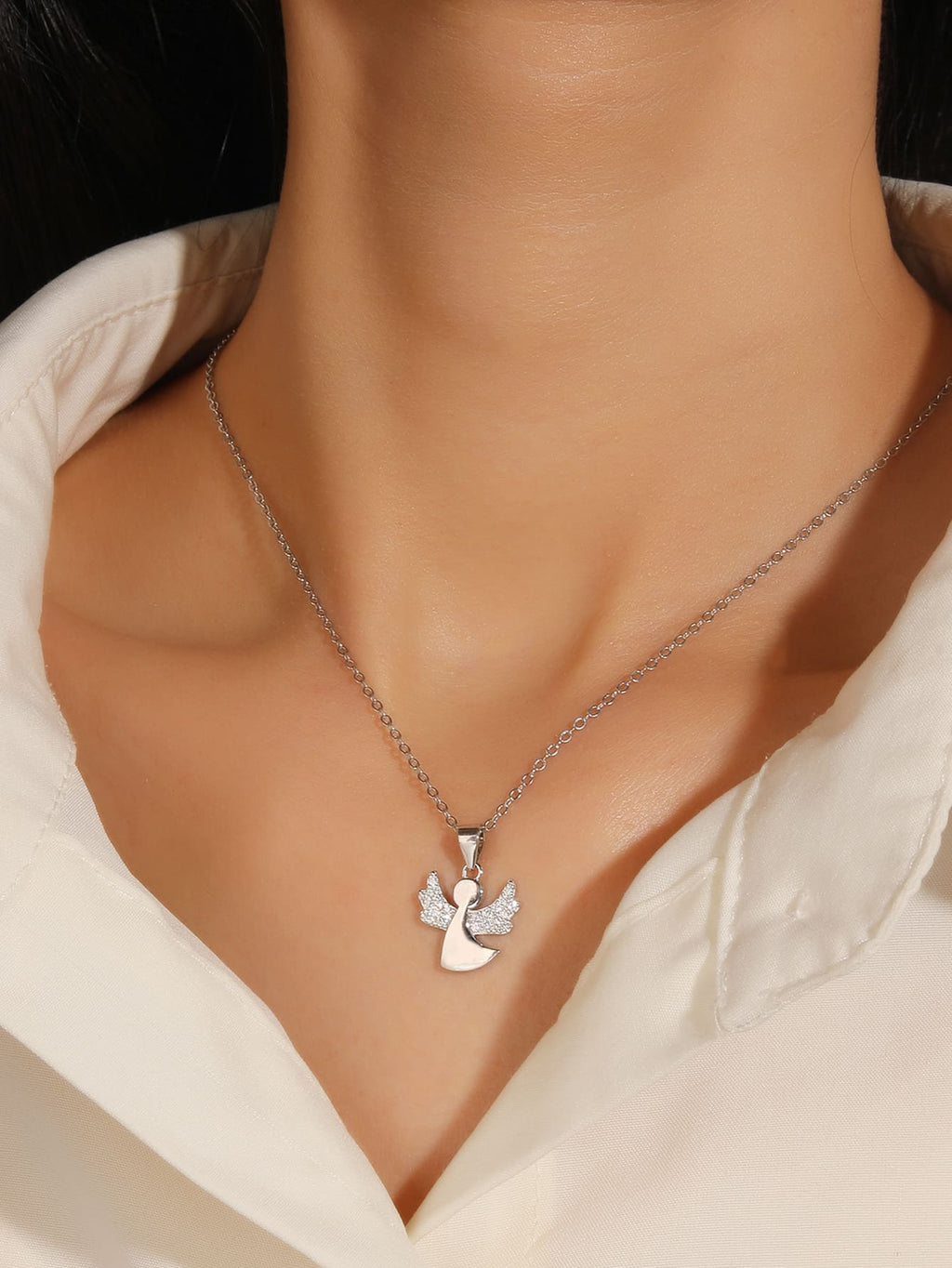 Cubic zirconia hallmarked, rhodium-plated 925 sterling silver angel pendant – worn view – DRESCHER Jewellery®