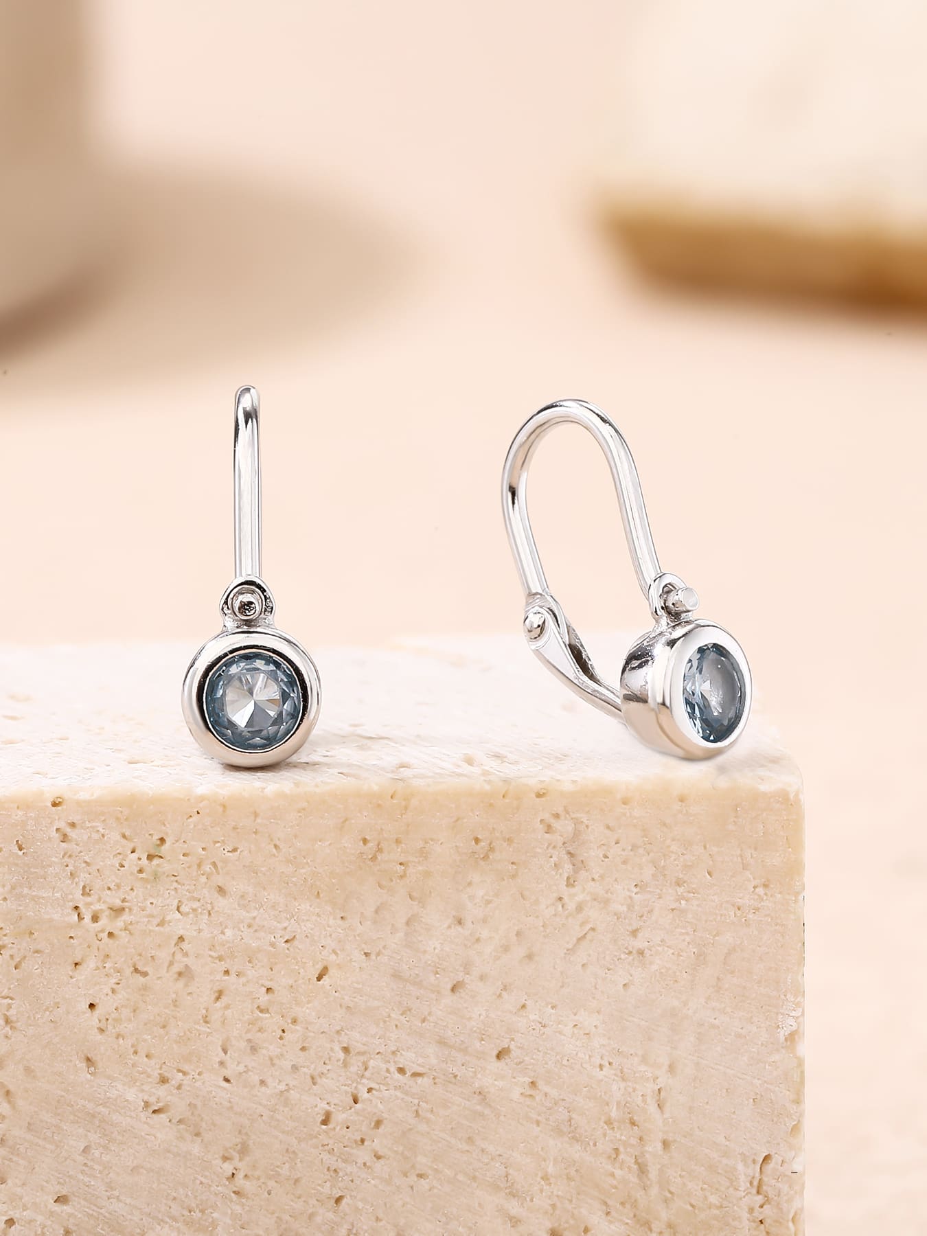 aqua blue stone baby earrings with front clasp in hallmarked, rhodium-plated 925 sterling silver – lifestyle view – DRESCHER Jewellery®