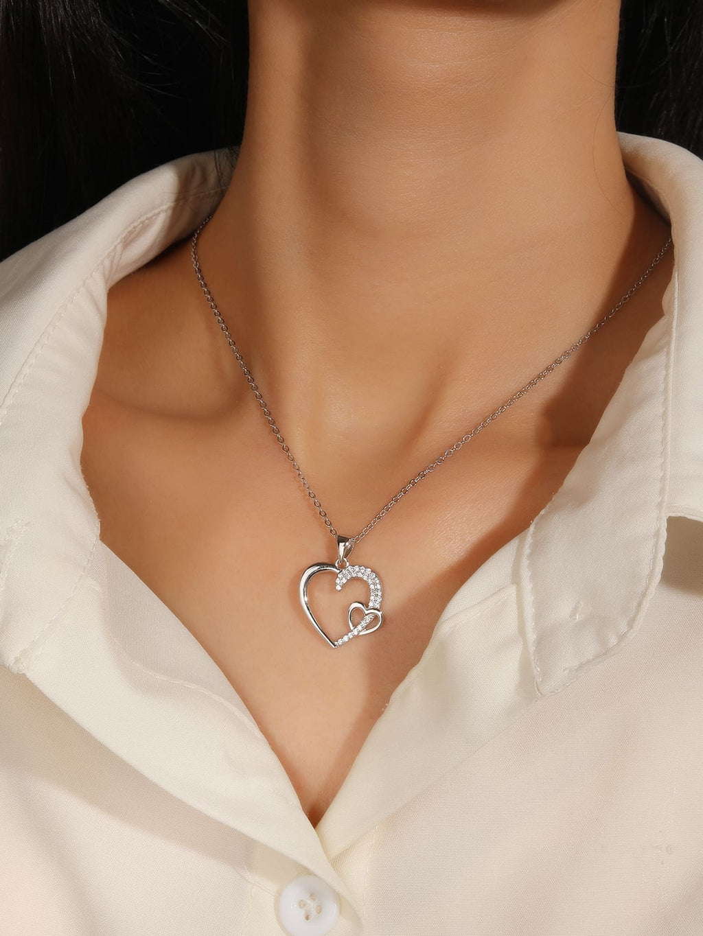 Asymmetrical heart pendant with zirconia in hallmarked, rhodium-plated 925 sterling silver – worn view – DRESCHER Jewellery®