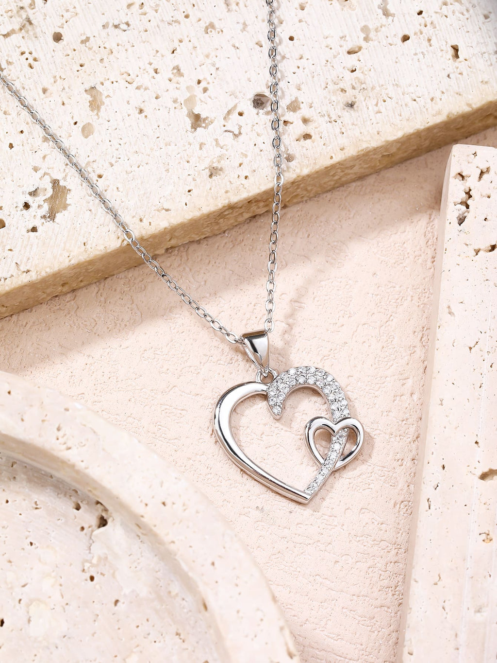 Asymmetrical heart pendant with zirconia in hallmarked, rhodium-plated 925 sterling silver – display view – DRESCHER Jewellery®