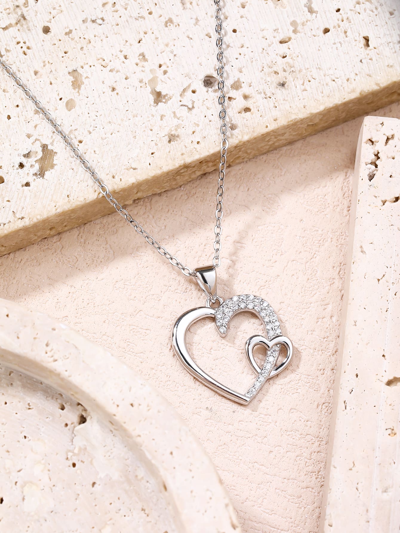Asymmetrical heart pendant with zirconia in hallmarked, rhodium-plated 925 sterling silver – display view – DRESCHER Jewellery®