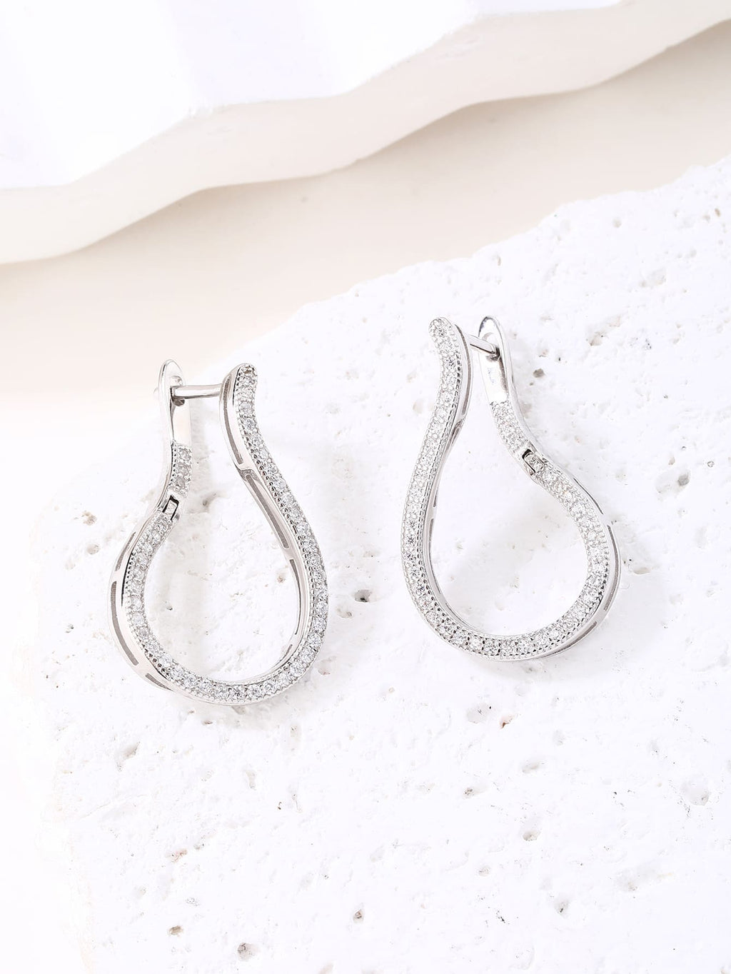 Twisted white cubic zirconia hoop earrings in hallmarked, rhodium-plated 925 sterling silver – display view – DRESCHER Jewellery®