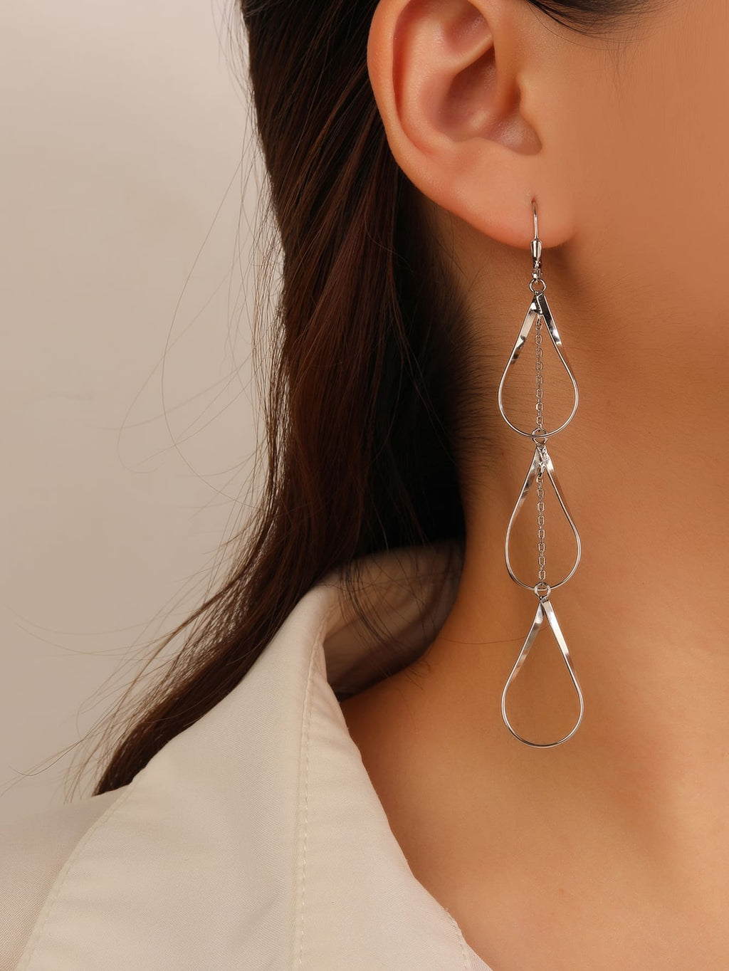 teardrop-shaped dangle earrings in hallmarked, rhodium-plated 925 sterling silver – worn view – DRESCHER Jewellery®