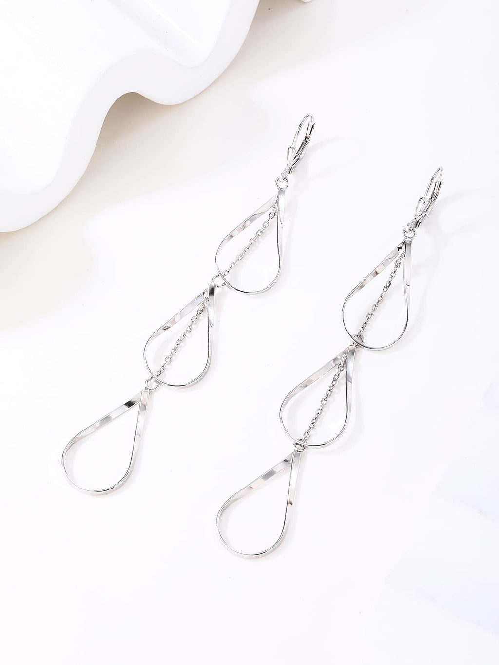 teardrop-shaped dangle earrings in hallmarked, rhodium-plated 925 sterling silver – display view – DRESCHER Jewellery®