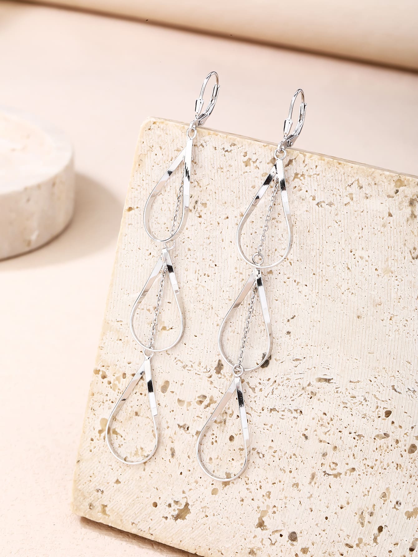 teardrop-shaped dangle earrings in hallmarked, rhodium-plated 925 sterling silver – lifestyle view – DRESCHER Jewellery®