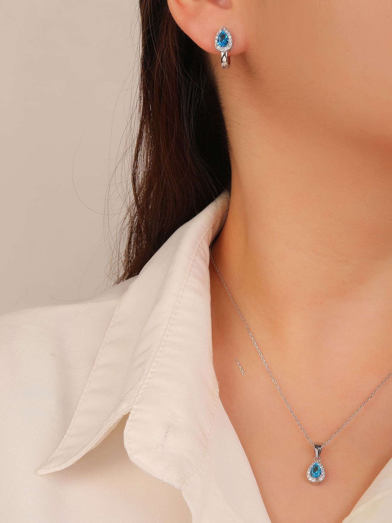 Drop shaped light blue stone set with white cubic zirconia stones (without chain) in hallmarked, rhodium-plated 925 sterling silver – worn view – DRESCHER Jewellery®