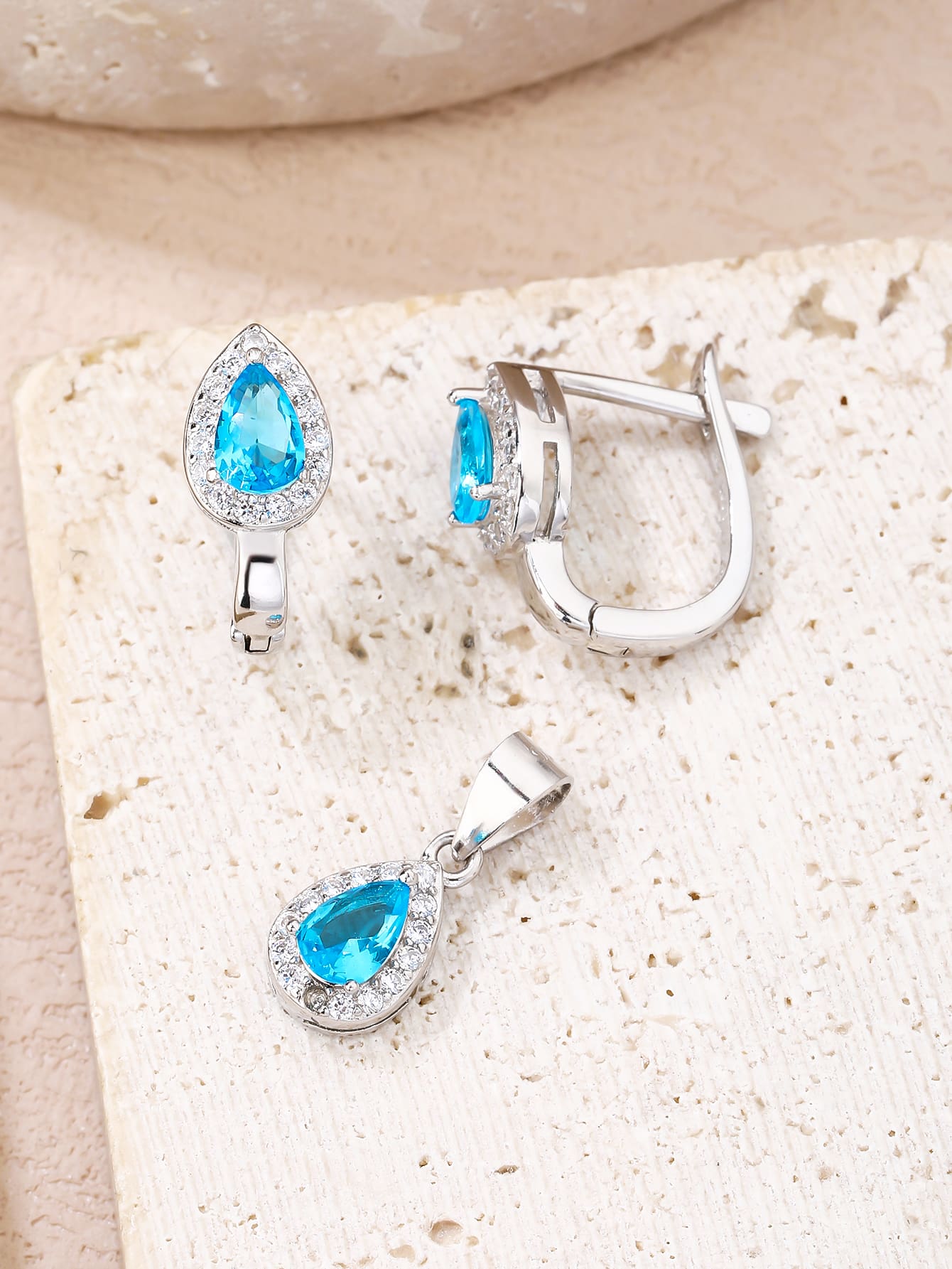 Drop shaped light blue stone set with white cubic zirconia stones (without chain) in hallmarked, rhodium-plated 925 sterling silver – display view – DRESCHER Jewellery®