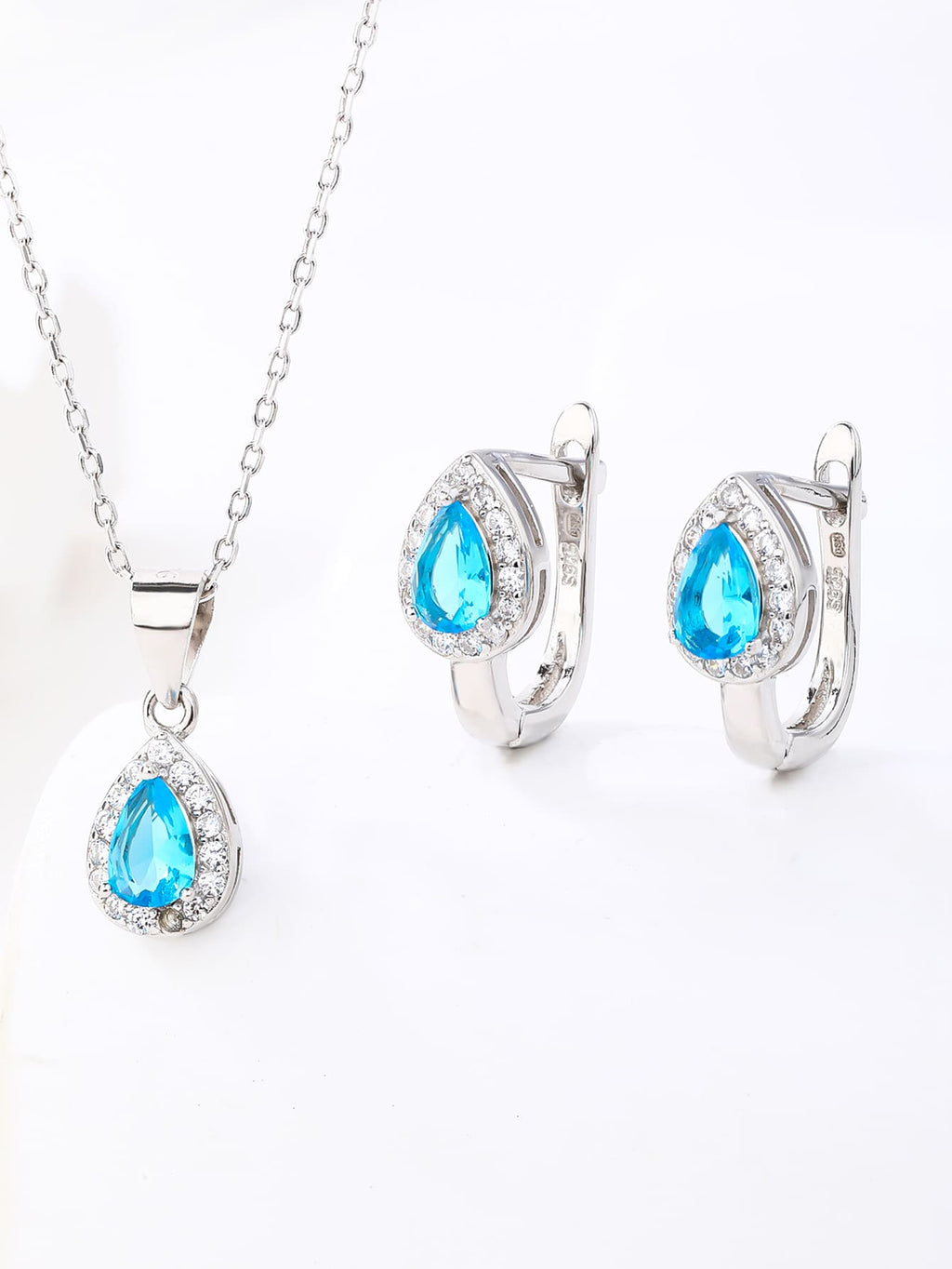 Drop shaped light blue stone set with white cubic zirconia stones (without chain) in hallmarked, rhodium-plated 925 sterling silver – lifestyle view – DRESCHER Jewellery®