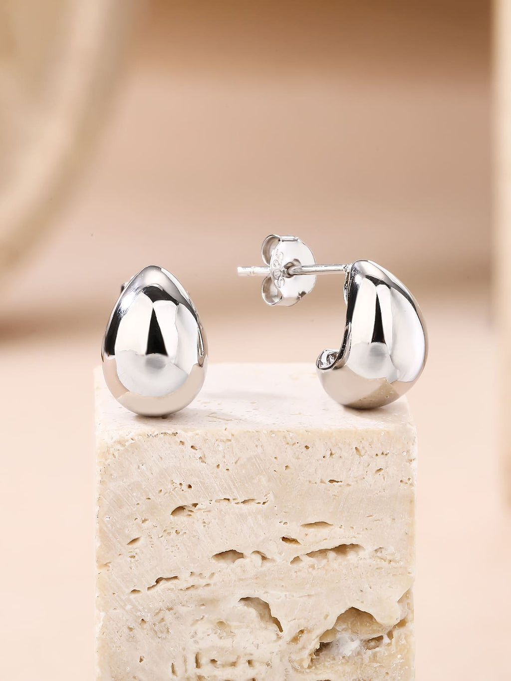 Teardrop-shaped hallmarked, rhodium-plated 925 sterling silver stud earrings – lifestyle view – DRESCHER Jewellery®
