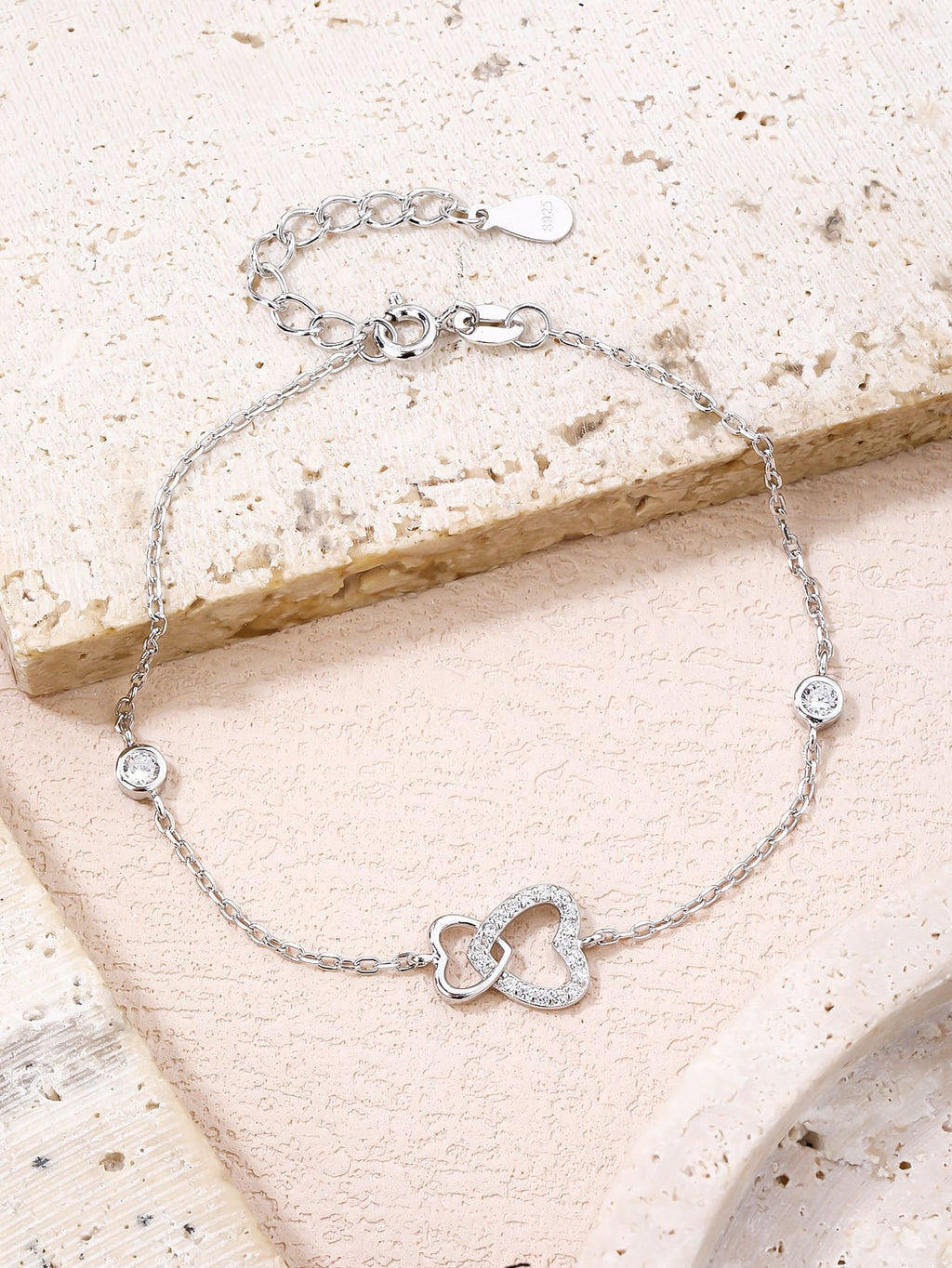 Double heart motif bracelet with cubic zirconia stones in hallmarked, rhodium-plated 925 sterling silver – worn view – DRESCHER Jewellery®