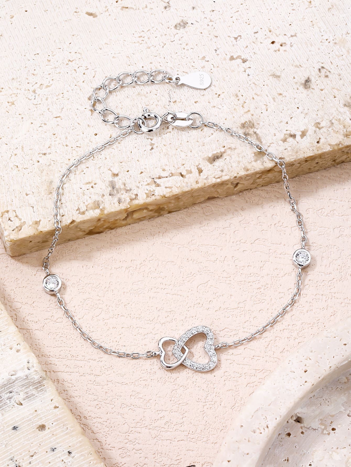 Double heart motif bracelet with cubic zirconia stones in hallmarked, rhodium-plated 925 sterling silver – worn view – DRESCHER Jewellery®