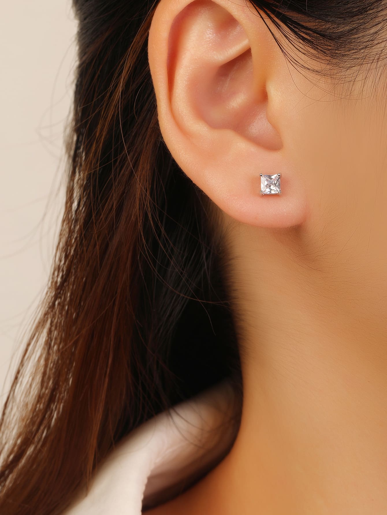 Square-cut white cubic zirconia four-prong stud earrings in hallmarked, rhodium-plated 925 sterling silver – worn view – DRESCHER Jewellery®