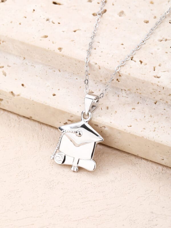 graduation medal in hallmarked, rhodium-plated 925 sterling silver – lifestyle view – DRESCHER Jewellery®