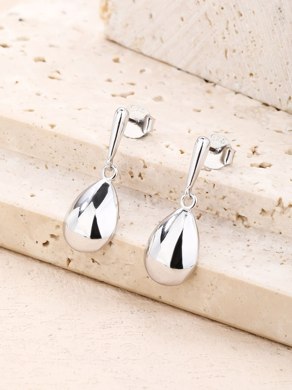 Polished teardrop dangle stud earrings in hallmarked, rhodium-plated 925 sterling silver – lifestyle view – DRESCHER Jewellery®