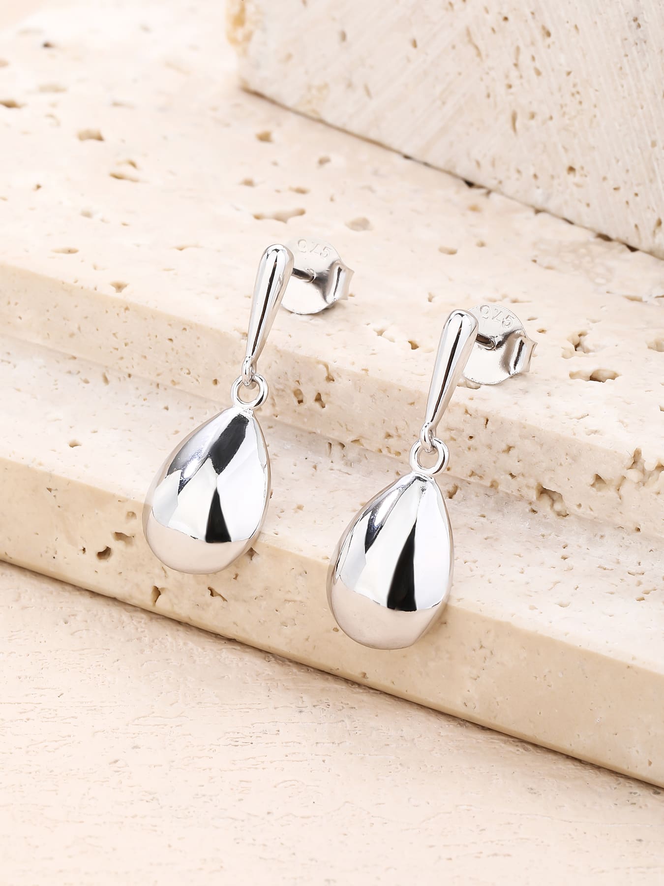 Polished teardrop dangle stud earrings in hallmarked, rhodium-plated 925 sterling silver – lifestyle view – DRESCHER Jewellery®