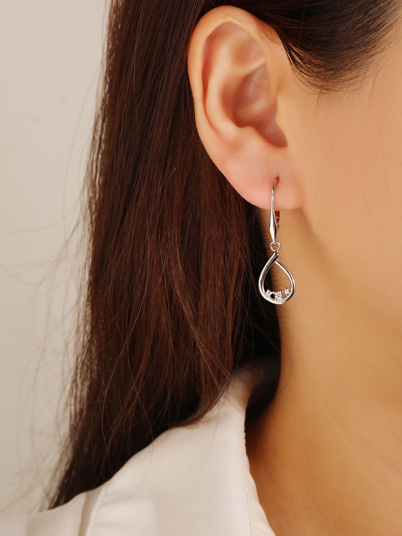 Teardrop white cubic zirconia leverback earrings in hallmarked, rhodium-plated 925 sterling silver – worn view – DRESCHER Jewellery®