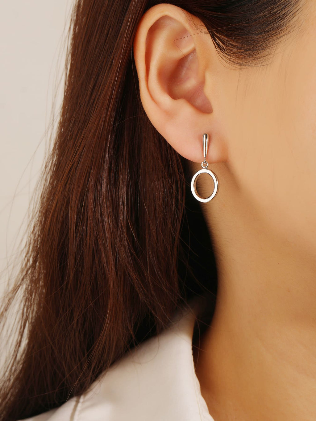 Open circle drop stud earrings in hallmarked, rhodium-plated 925 sterling silver – worn view – DRESCHER Jewellery®