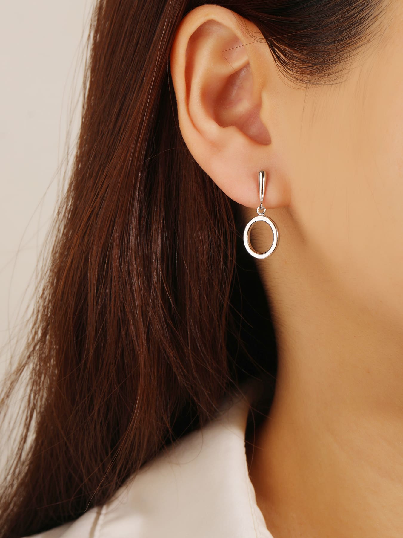 Open circle drop stud earrings in hallmarked, rhodium-plated 925 sterling silver – worn view – DRESCHER Jewellery®