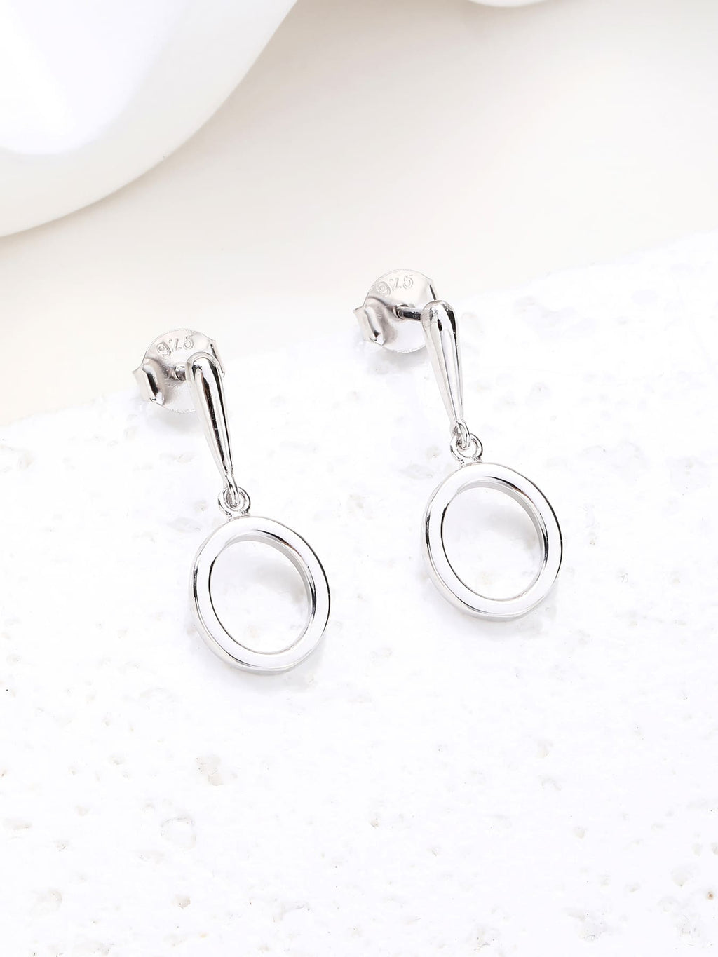 Open circle drop stud earrings in hallmarked, rhodium-plated 925 sterling silver – display view – DRESCHER Jewellery®