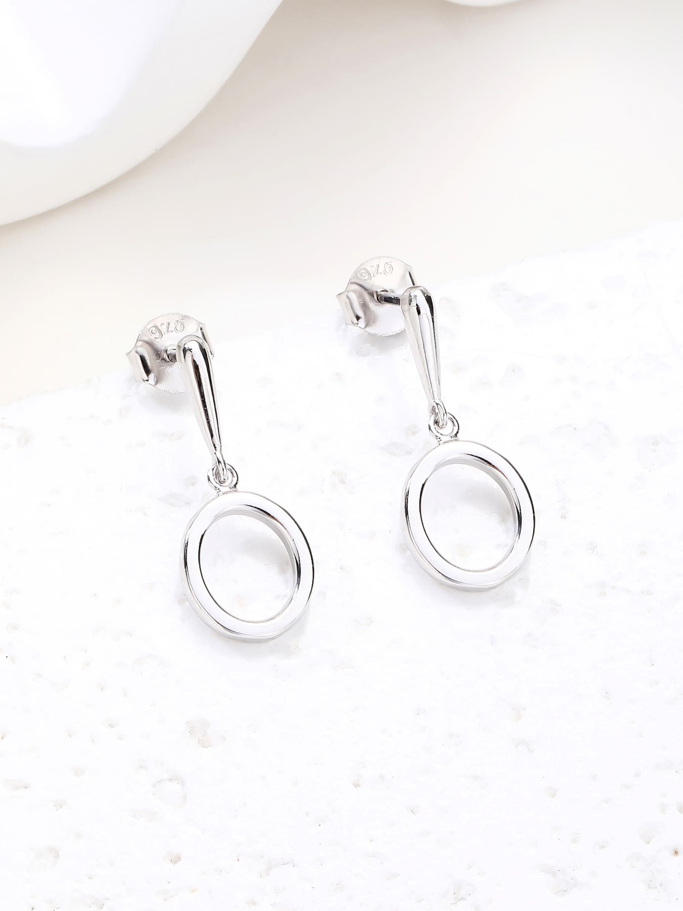 Open circle drop stud earrings in hallmarked, rhodium-plated 925 sterling silver – display view – DRESCHER Jewellery®