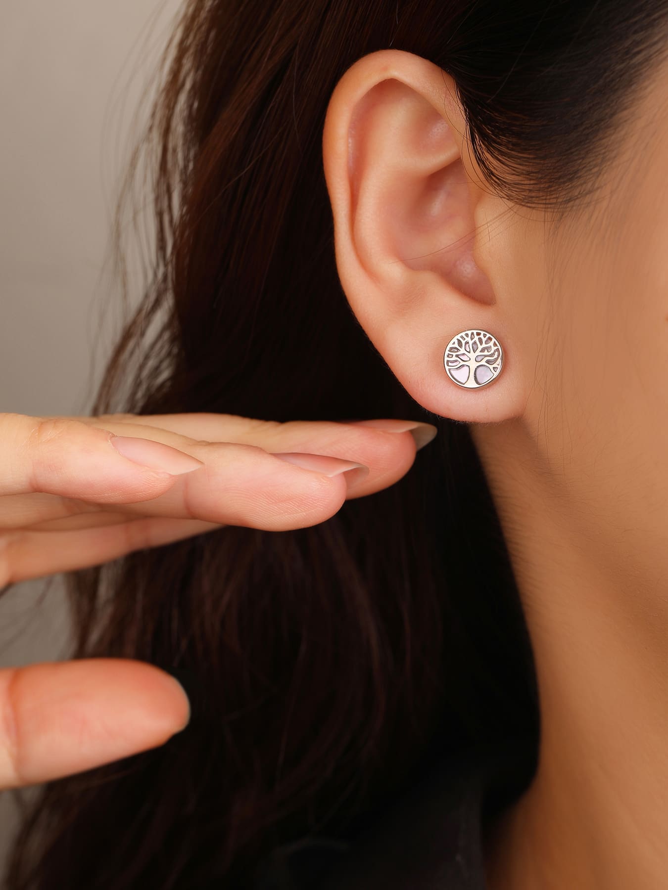 Tree of life stud earrings with mother-of-pearl inlays and silver components crafted from hallmarked, rhodium-plated 925 sterling silver – worn view – DRESCHER Jewellery®
