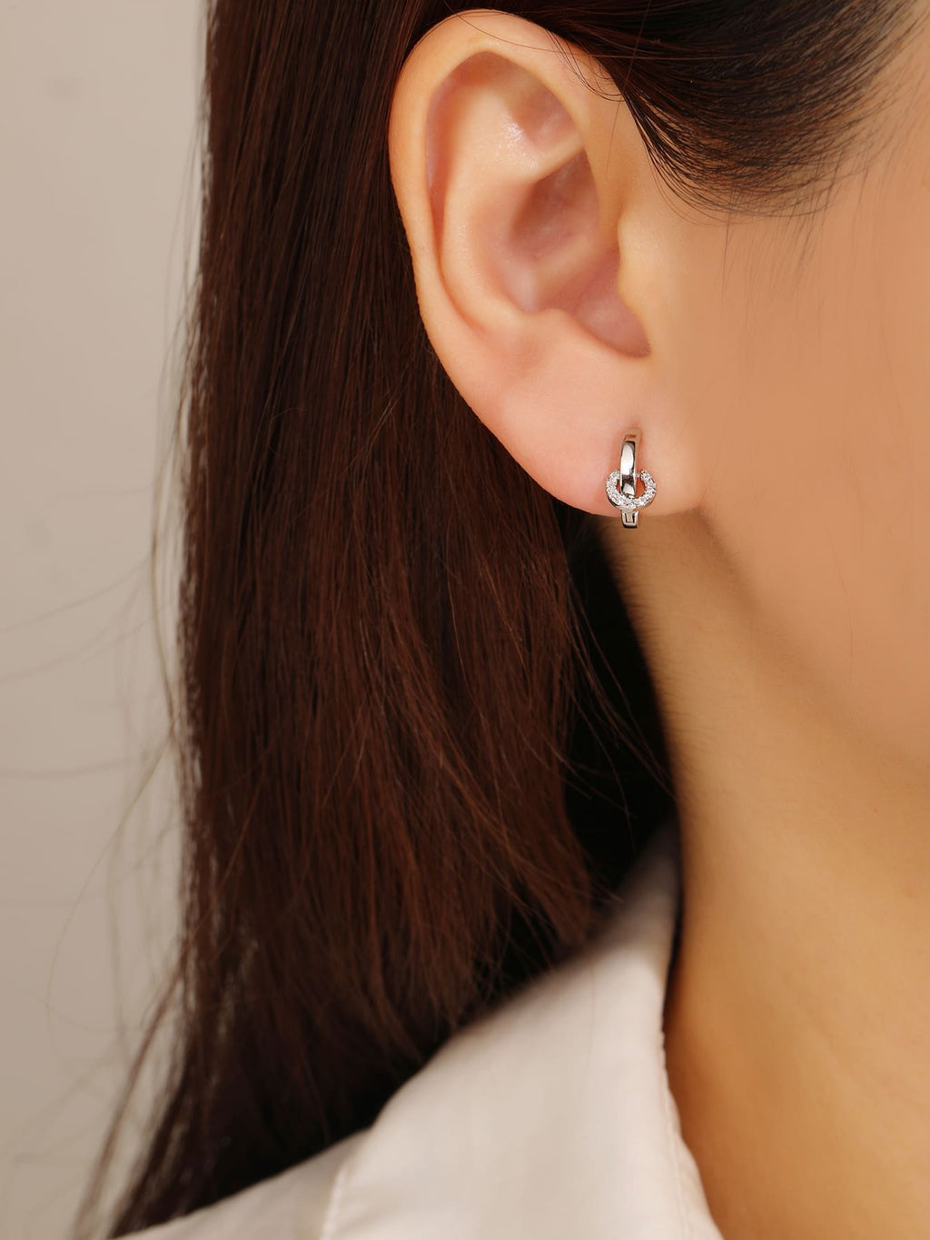 white cubic zirconia stone hoop earrings in hallmarked, rhodium-plated 925 sterling silver – worn view – DRESCHER Jewellery®