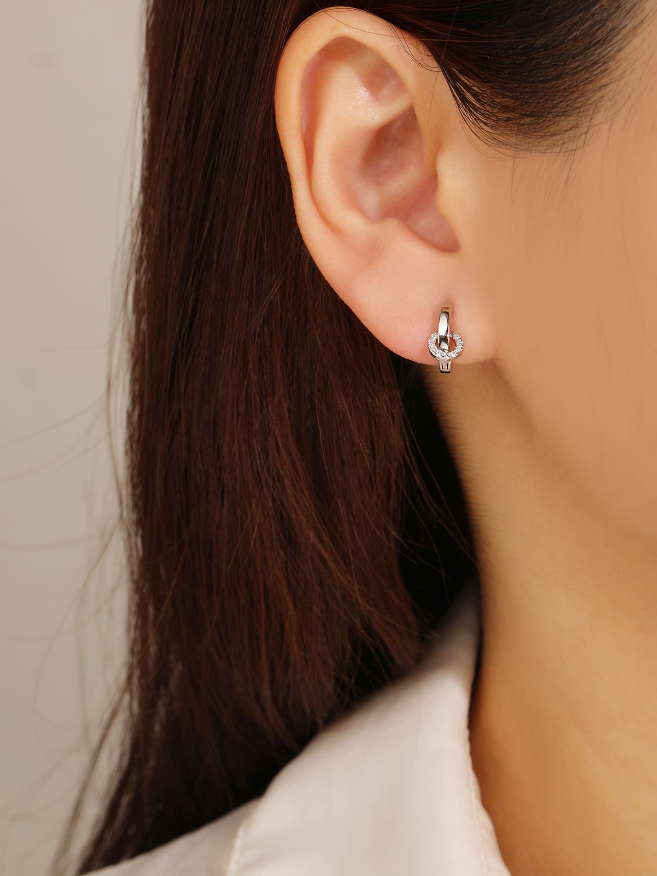 white cubic zirconia stone hoop earrings in hallmarked, rhodium-plated 925 sterling silver – worn view – DRESCHER Jewellery®