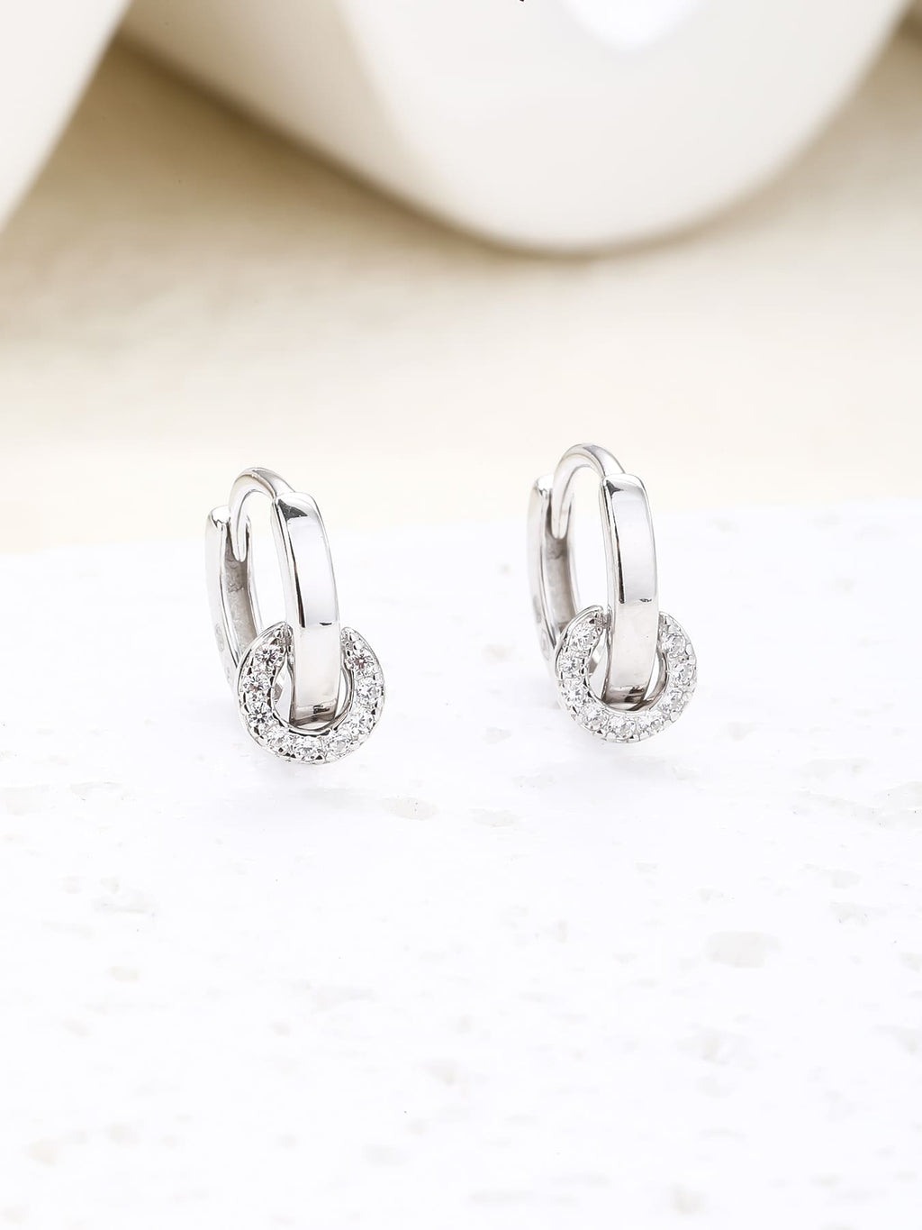white cubic zirconia stone hoop earrings in hallmarked, rhodium-plated 925 sterling silver – lifestyle view – DRESCHER Jewellery®