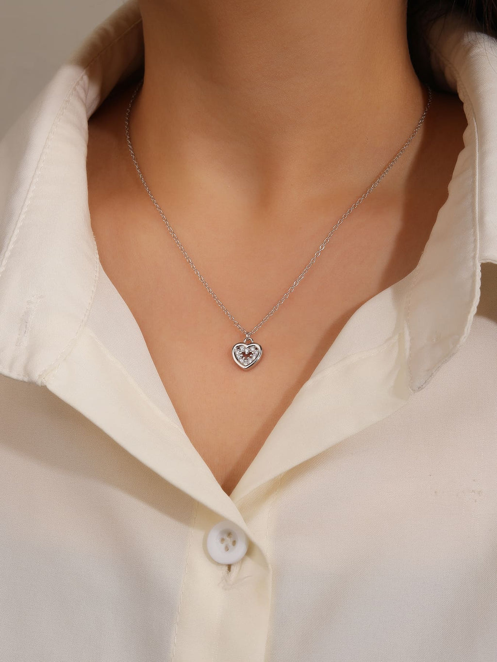 white stone heart necklace in hallmarked, rhodium-plated 925 sterling silver – worn view – DRESCHER Jewellery®
