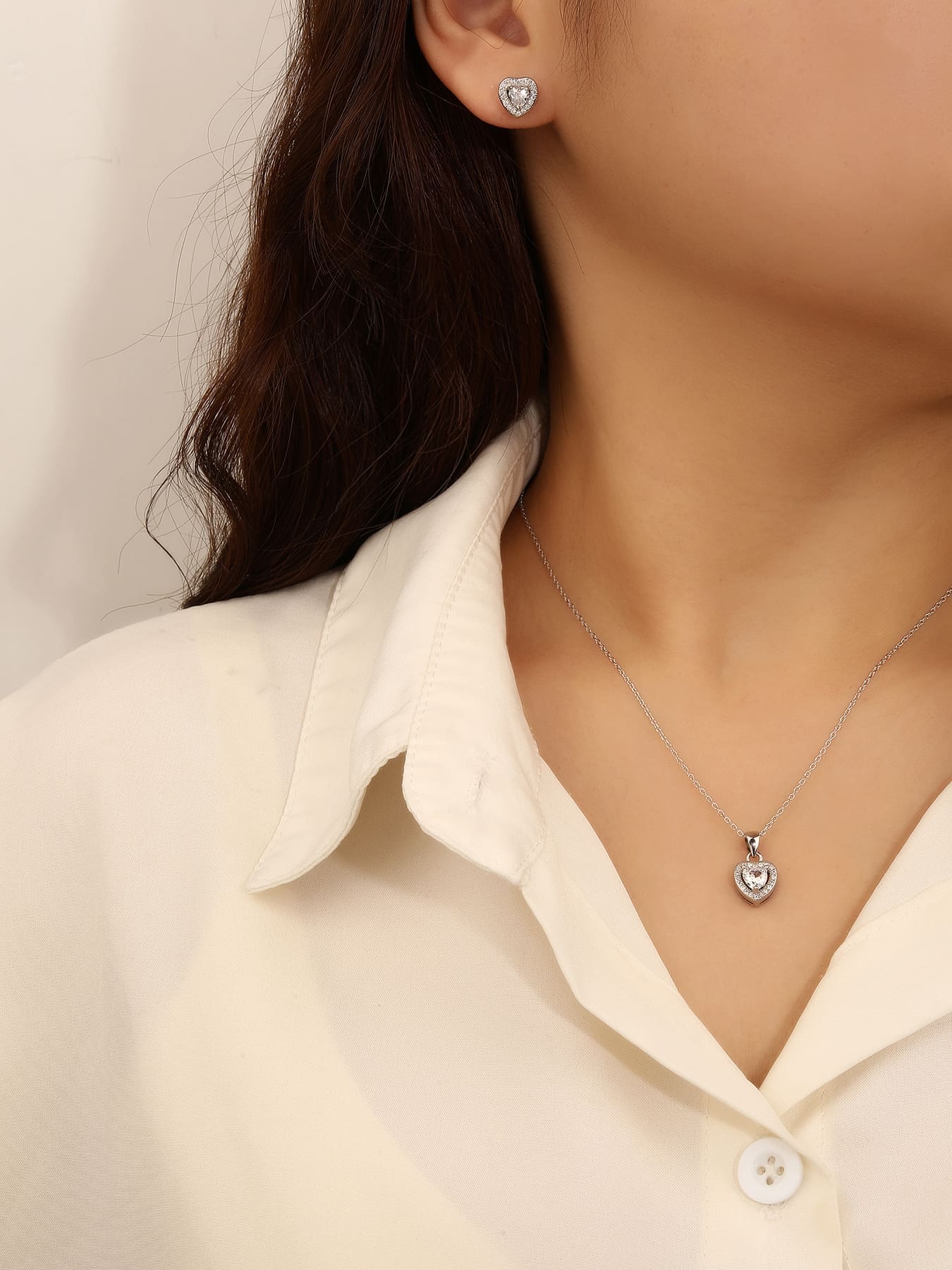 white heart shaped zirconia stud earrings and pendant set in hallmarked, rhodium-plated 925 sterling silver – worn view – DRESCHER Jewellery®