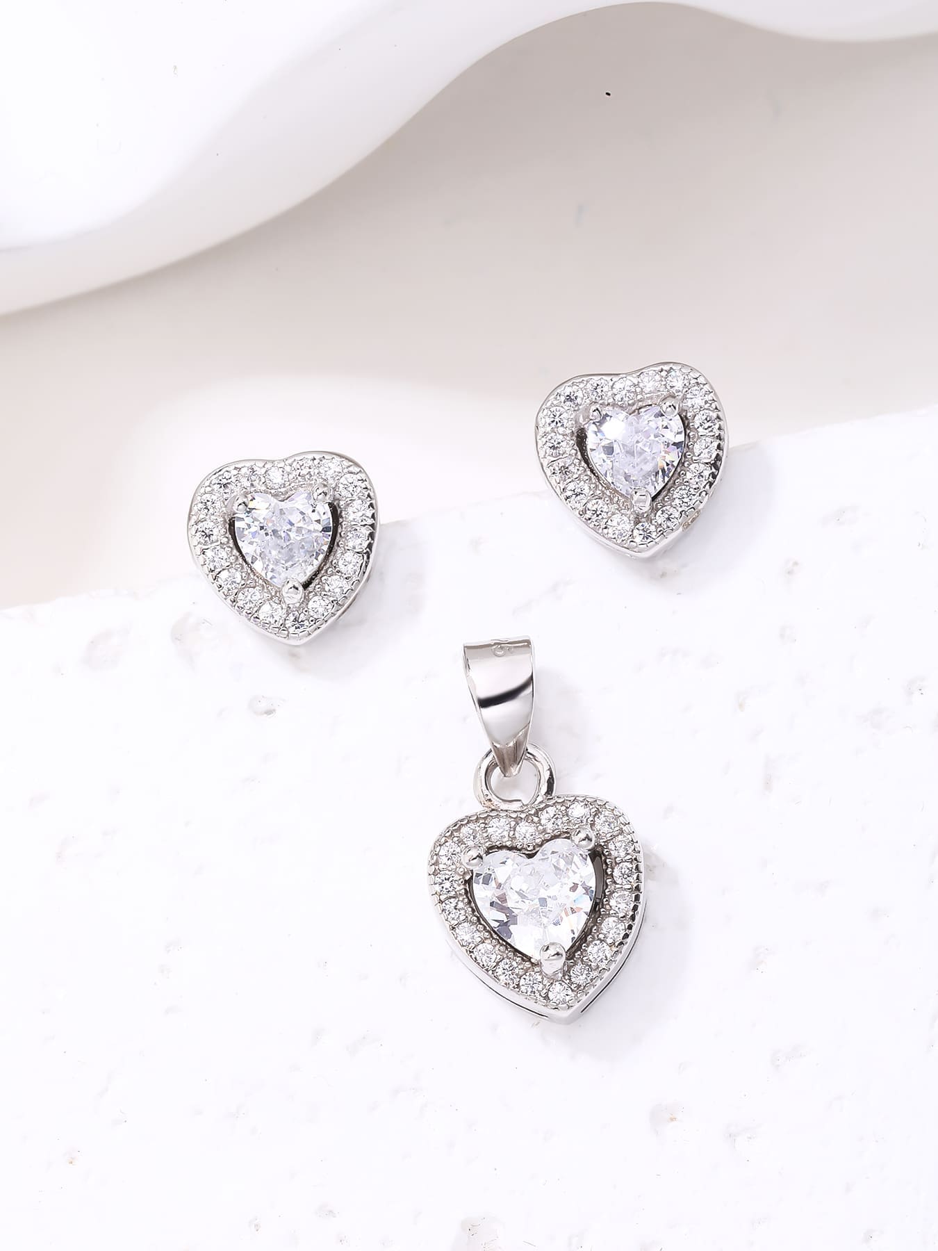 white heart shaped zirconia stud earrings and pendant set in hallmarked, rhodium-plated 925 sterling silver – lifestyle view – DRESCHER Jewellery®