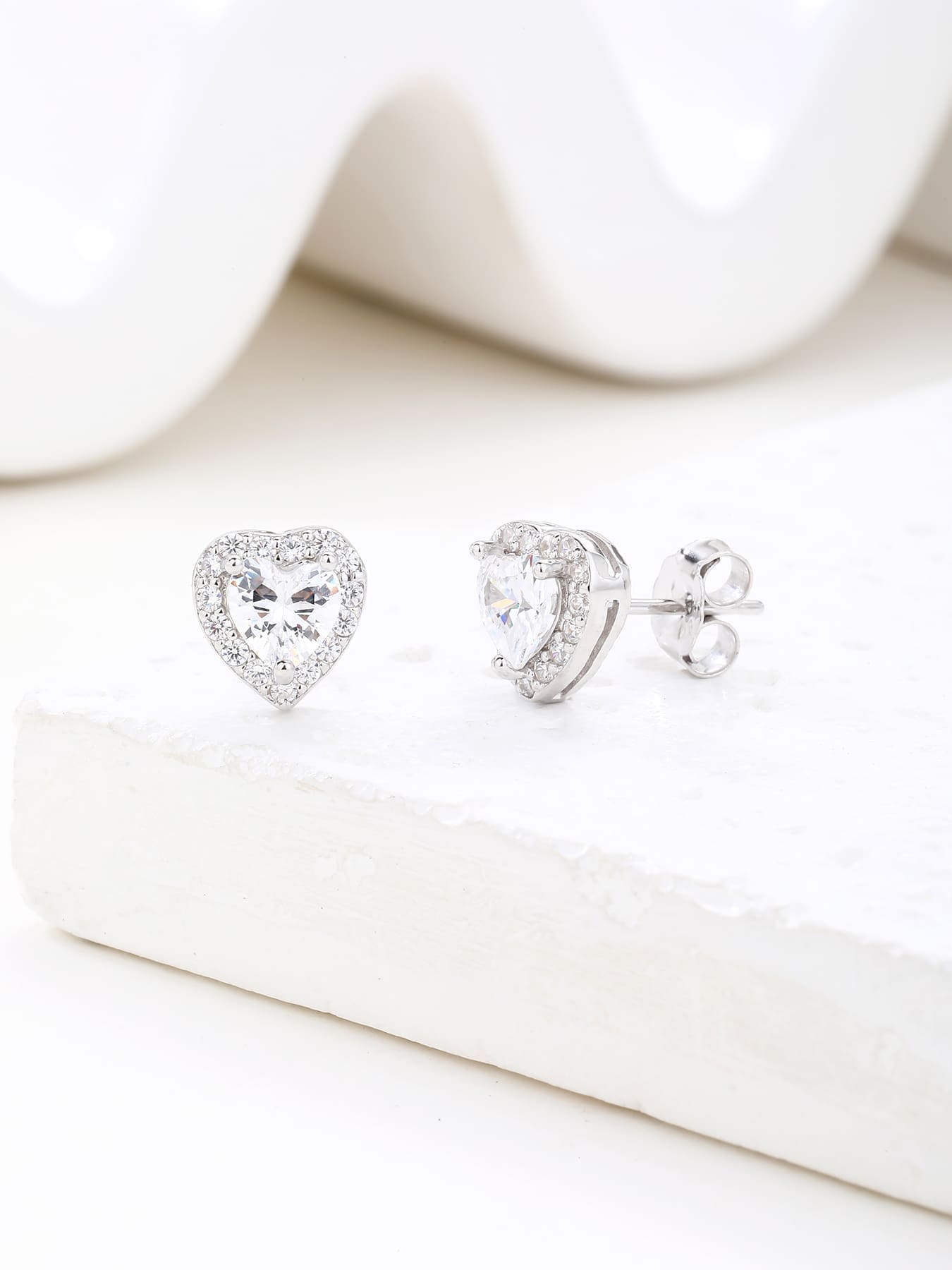 white heart shaped stone stud earrings with white cubic zirconia in hallmarked, rhodium-plated 925 sterling silver – display view – DRESCHER Jewellery®