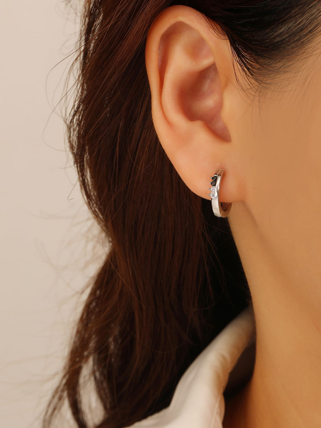 Black and white cubic zirconia hoop earrings in hallmarked, rhodium-plated 925 sterling silver – worn view – DRESCHER Jewellery®