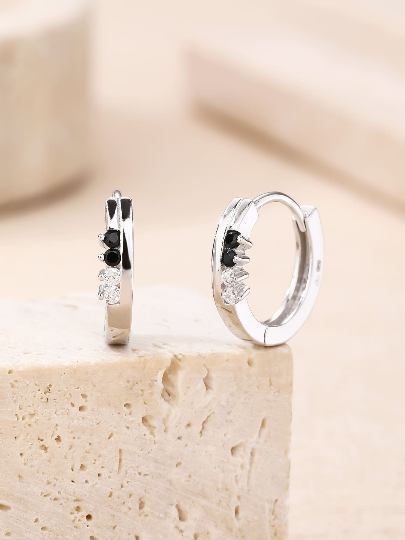 Black and white cubic zirconia hoop earrings in hallmarked, rhodium-plated 925 sterling silver – display view – DRESCHER Jewellery®