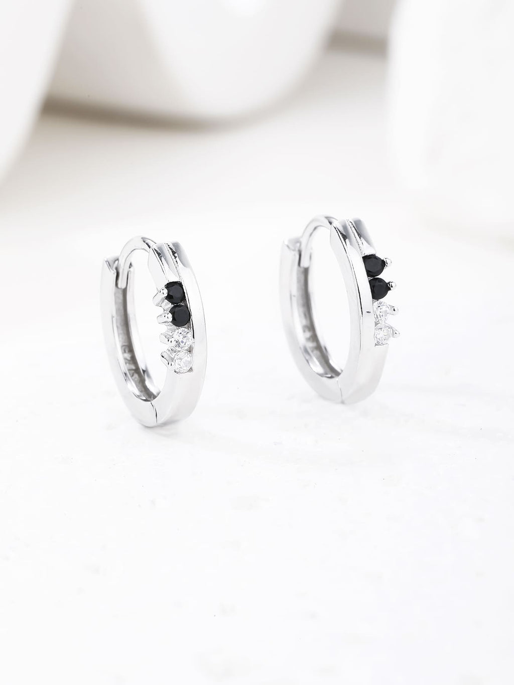 Black and white cubic zirconia hoop earrings in hallmarked, rhodium-plated 925 sterling silver – display view – DRESCHER Jewellery®