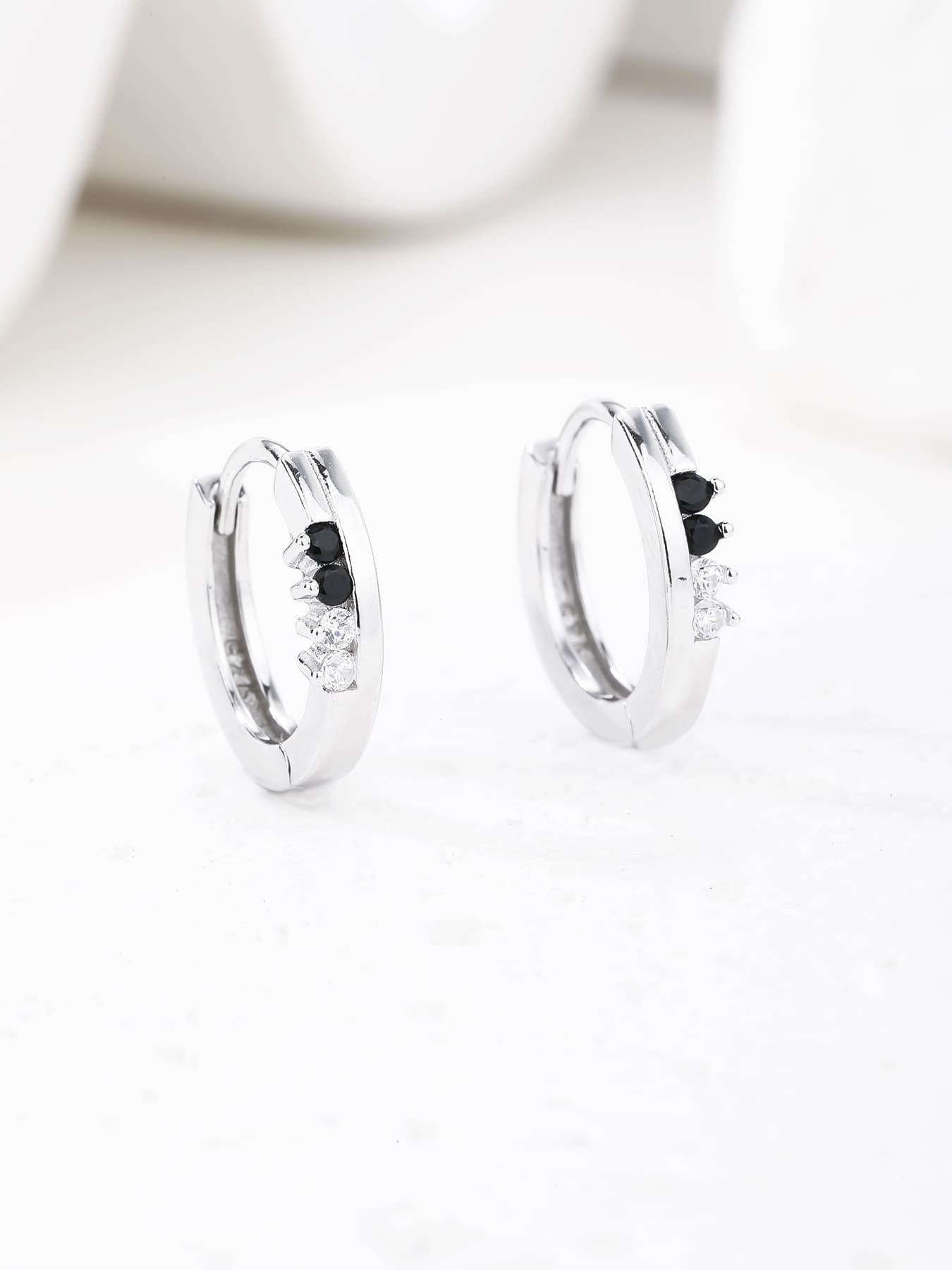 Black and white cubic zirconia hoop earrings in hallmarked, rhodium-plated 925 sterling silver – display view – DRESCHER Jewellery®