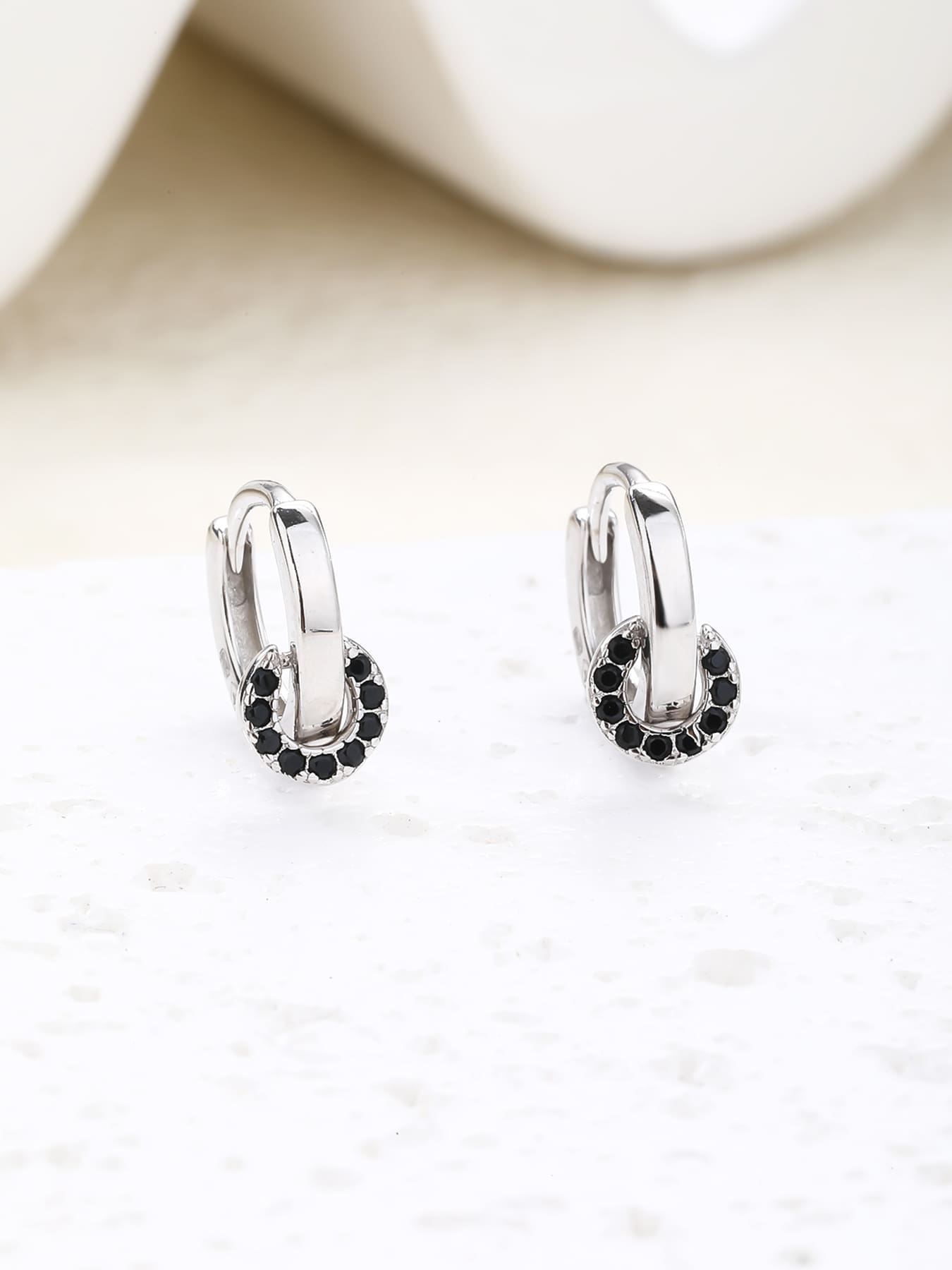 Black stone circle-detail hoop earrings in hallmarked, rhodium-plated 925 sterling silver – display view – DRESCHER Jewellery®
