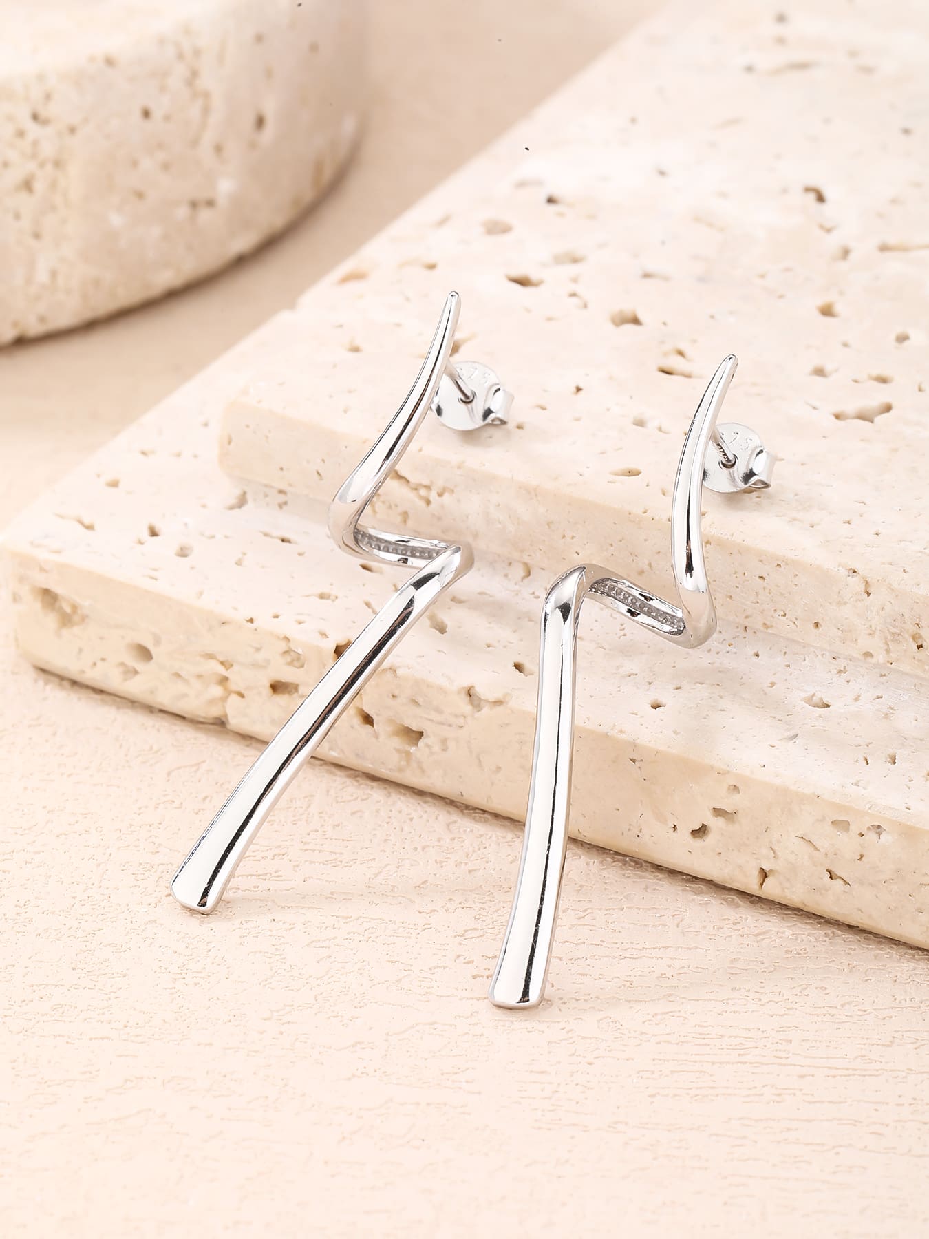 Abstract wave-form drop stud earrings in hallmarked, rhodium-plated 925 sterling silver – lifestyle view – DRESCHER Jewellery®