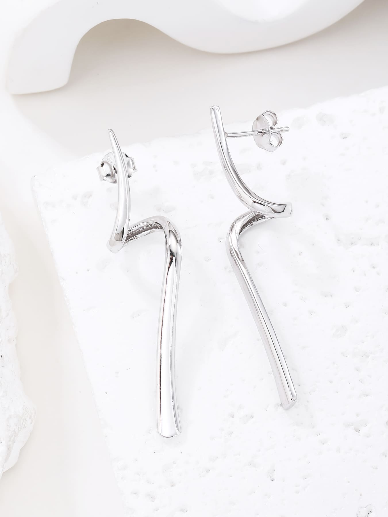 Abstract wave-form drop stud earrings in hallmarked, rhodium-plated 925 sterling silver – display view – DRESCHER Jewellery®