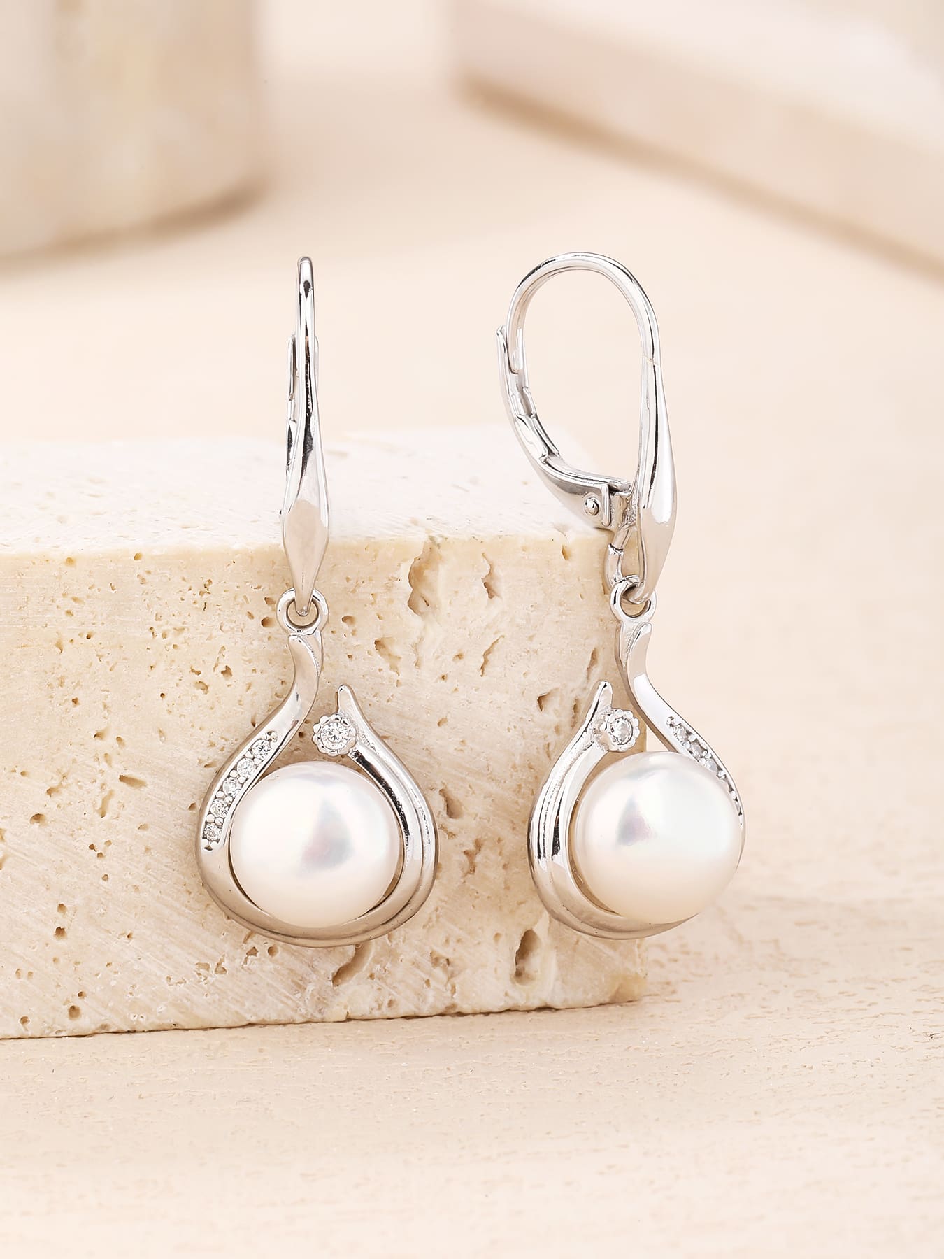 Pearl and white cubic zirconia teardrop leverback earrings, with silver components crafted from hallmarked, rhodium-plated 925 sterling silver – lifestyle view – DRESCHER Jewellery®
