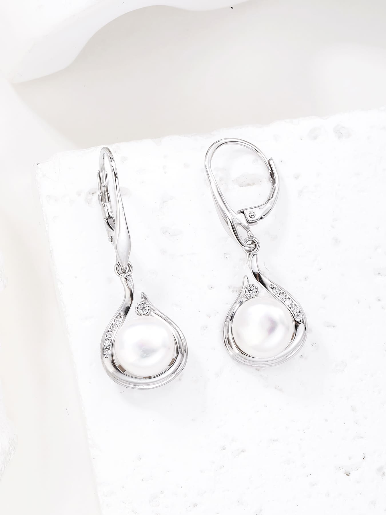Pearl and white cubic zirconia teardrop leverback earrings, with silver components crafted from hallmarked, rhodium-plated 925 sterling silver – display view – DRESCHER Jewellery®