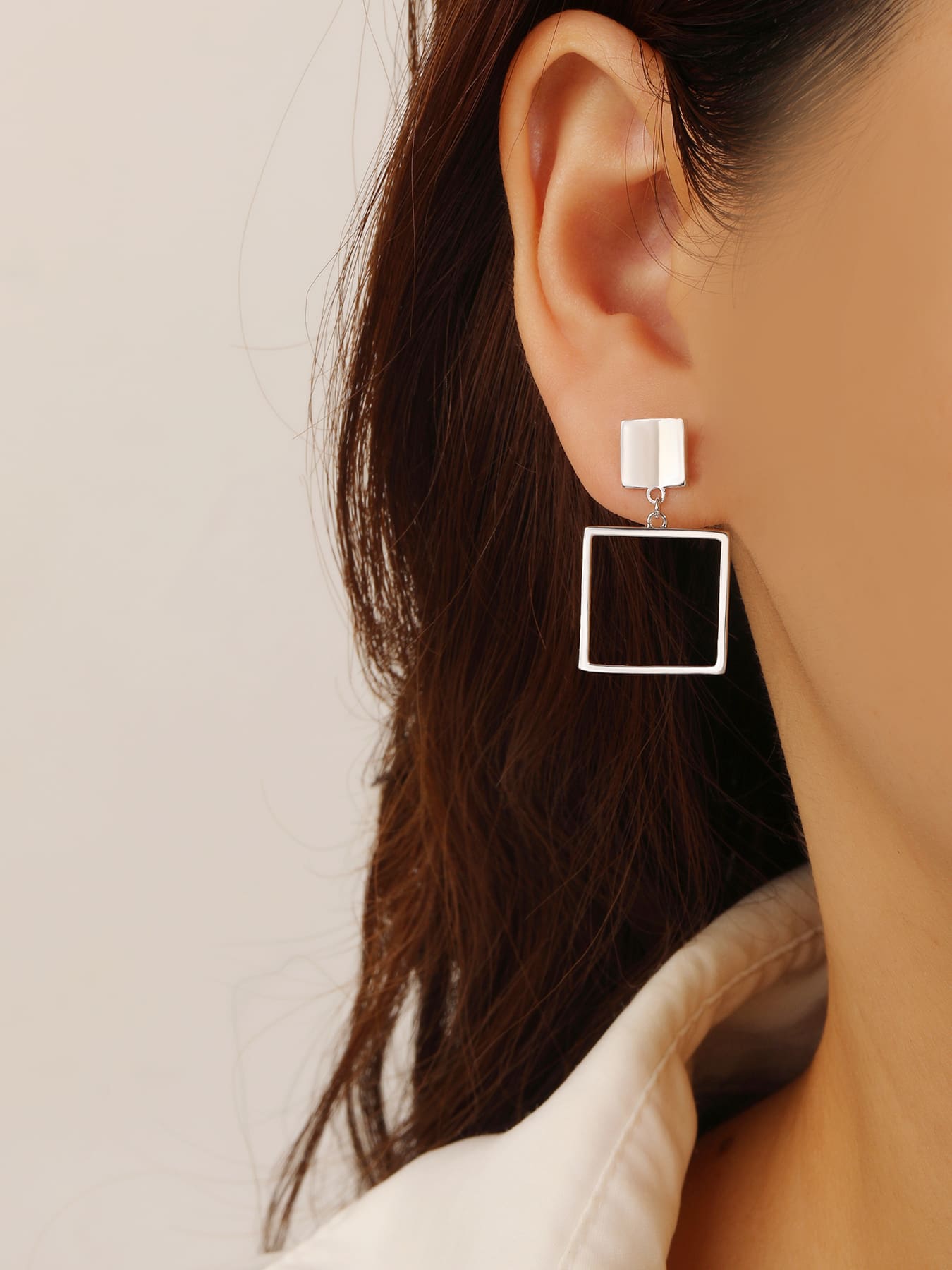 Minimalist open-square drop stud earrings in hallmarked, rhodium-plated 925 sterling silver – worn view – DRESCHER Jewellery®