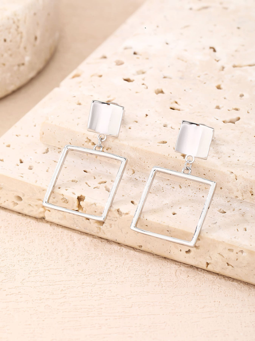 Minimalist open-square drop stud earrings in hallmarked, rhodium-plated 925 sterling silver – lifestyle view – DRESCHER Jewellery®