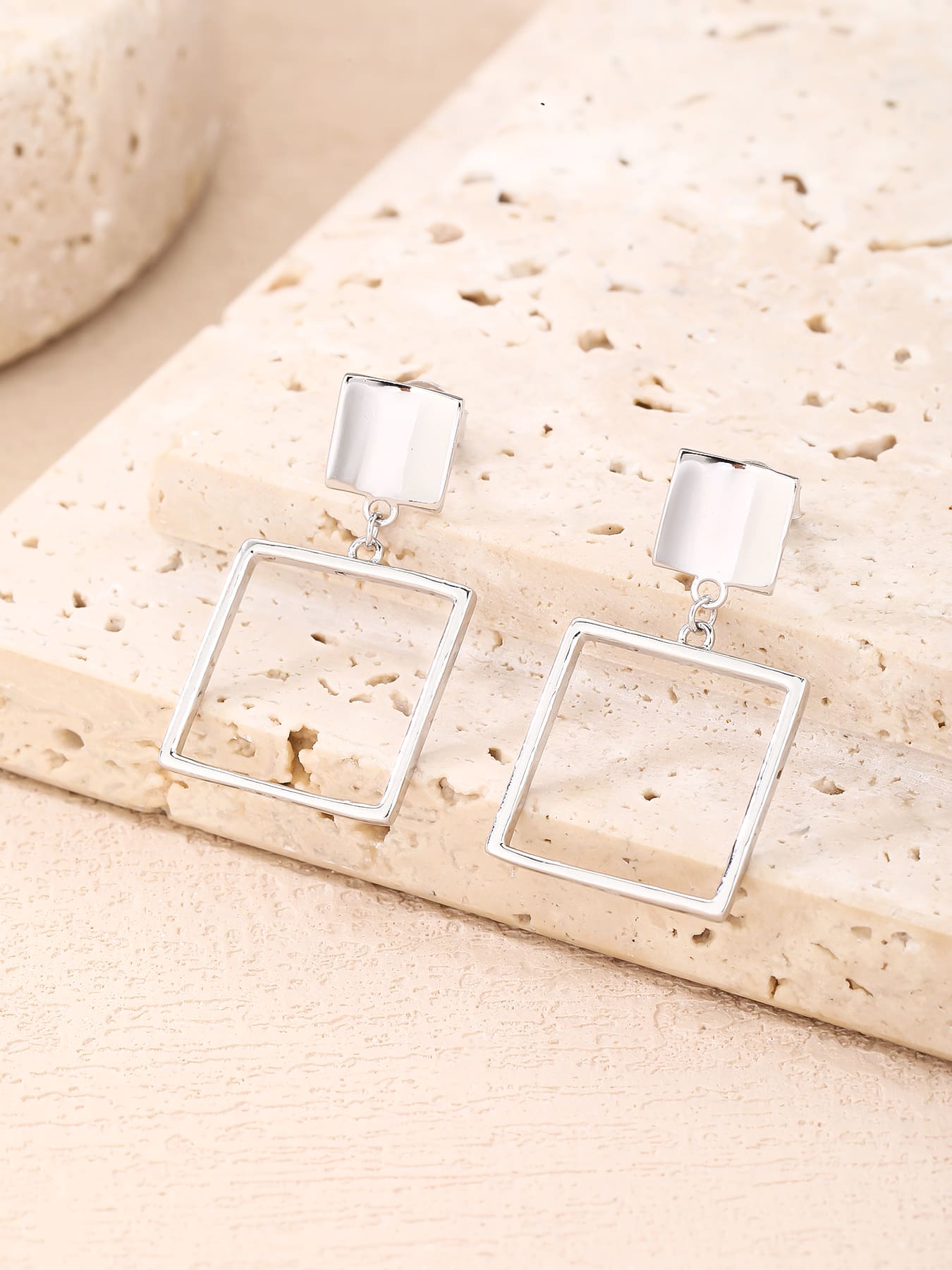 Minimalist open-square drop stud earrings in hallmarked, rhodium-plated 925 sterling silver – lifestyle view – DRESCHER Jewellery®