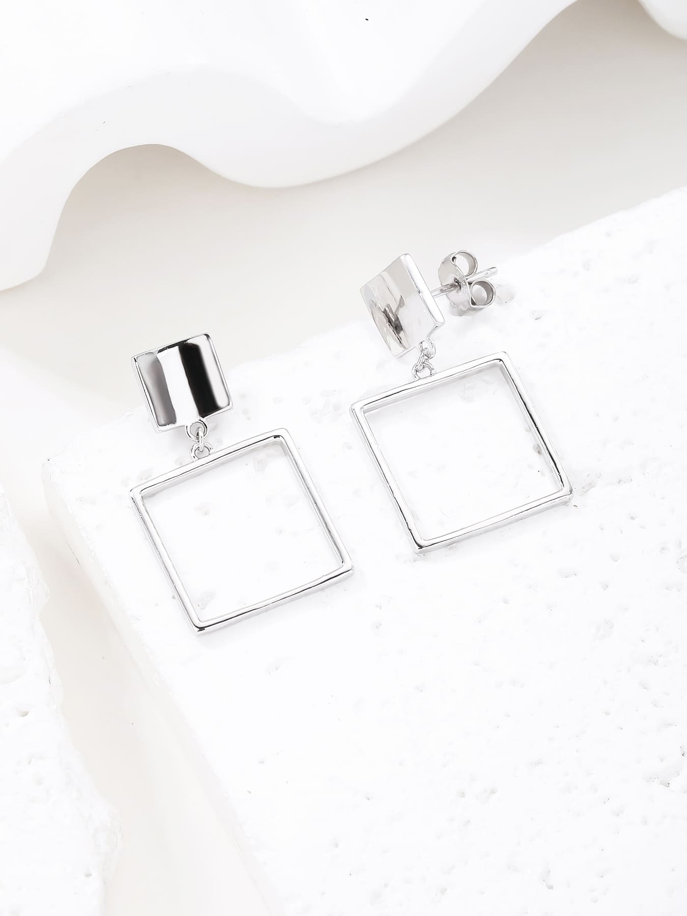 Minimalist open-square drop stud earrings in hallmarked, rhodium-plated 925 sterling silver – display view – DRESCHER Jewellery®