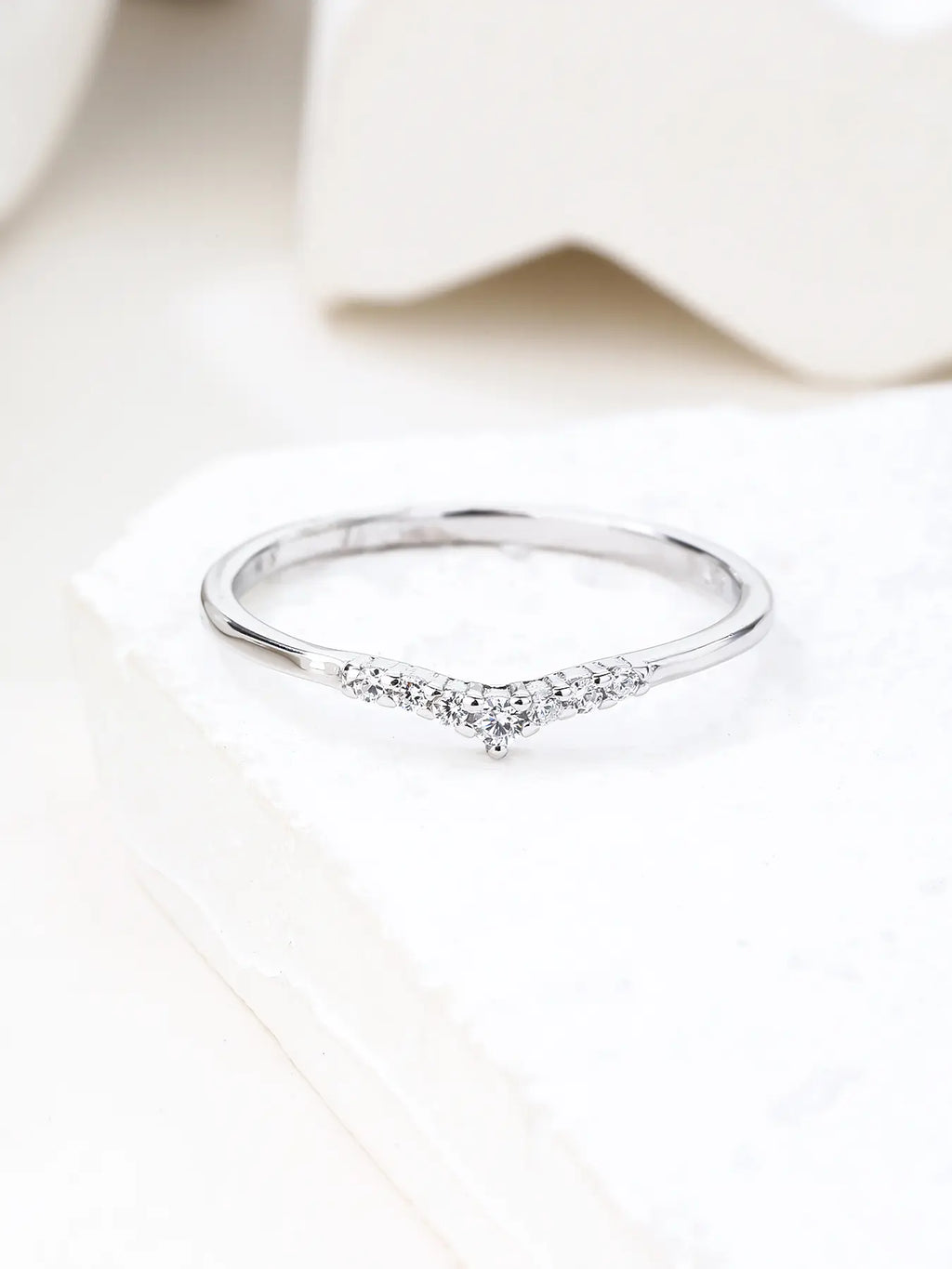 Silver ring with white cubic zirconia stones and V-shaped decoration